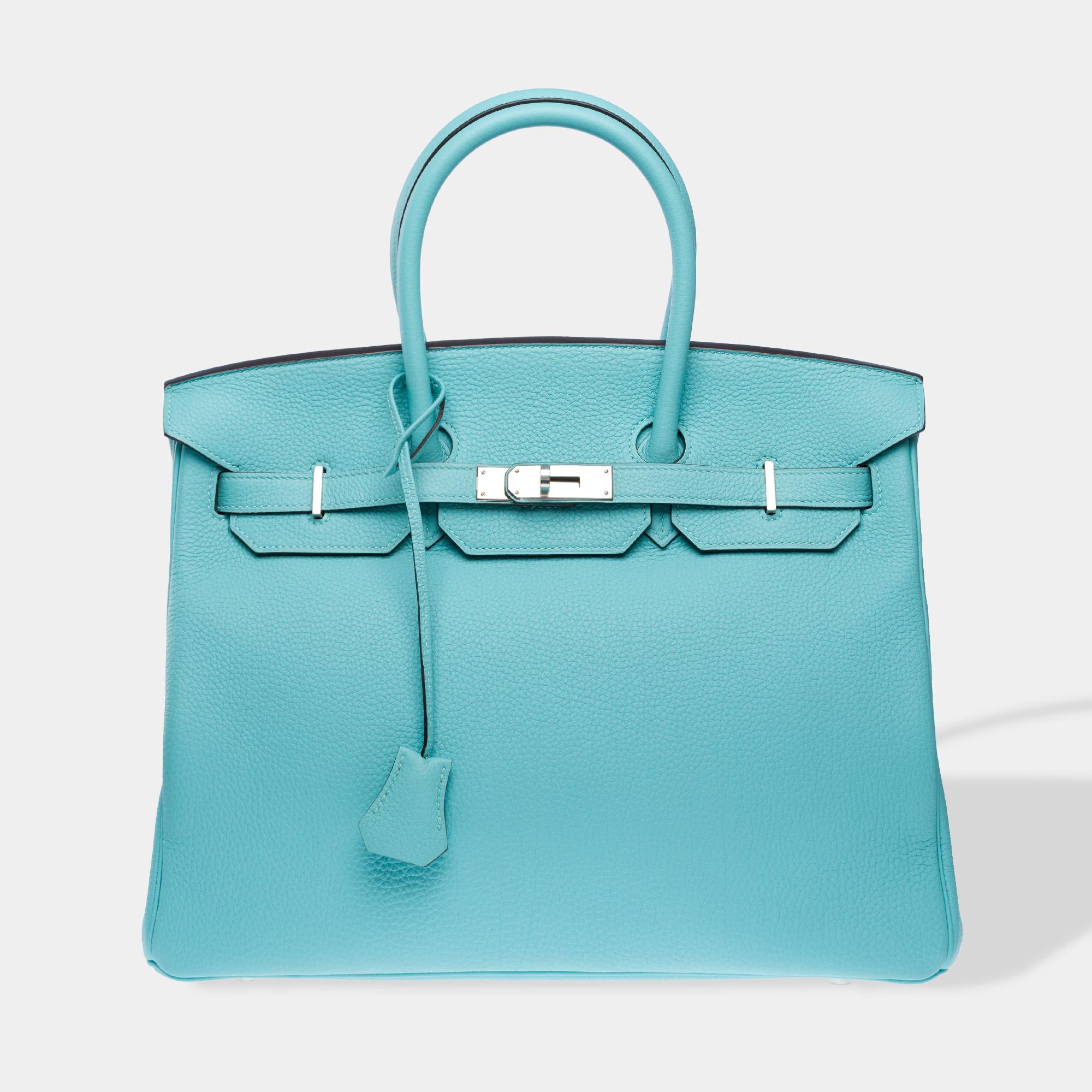 Splendid​ ​and​ ​Rare​ ​Hermes​ ​Birkin​ ​35​ ​handbag​ ​in​ ​Blue​ ​Atoll​ ​Togo​ ​calf​ ​leather,​ ​silver​ ​palladium​ ​metal​ ​trim,​ ​double​ ​blue​ ​leather​ ​handles​ ​allowing​ ​for​ ​hand​ ​carry

Closure​ ​with​ ​flap
Blue​ ​leather​