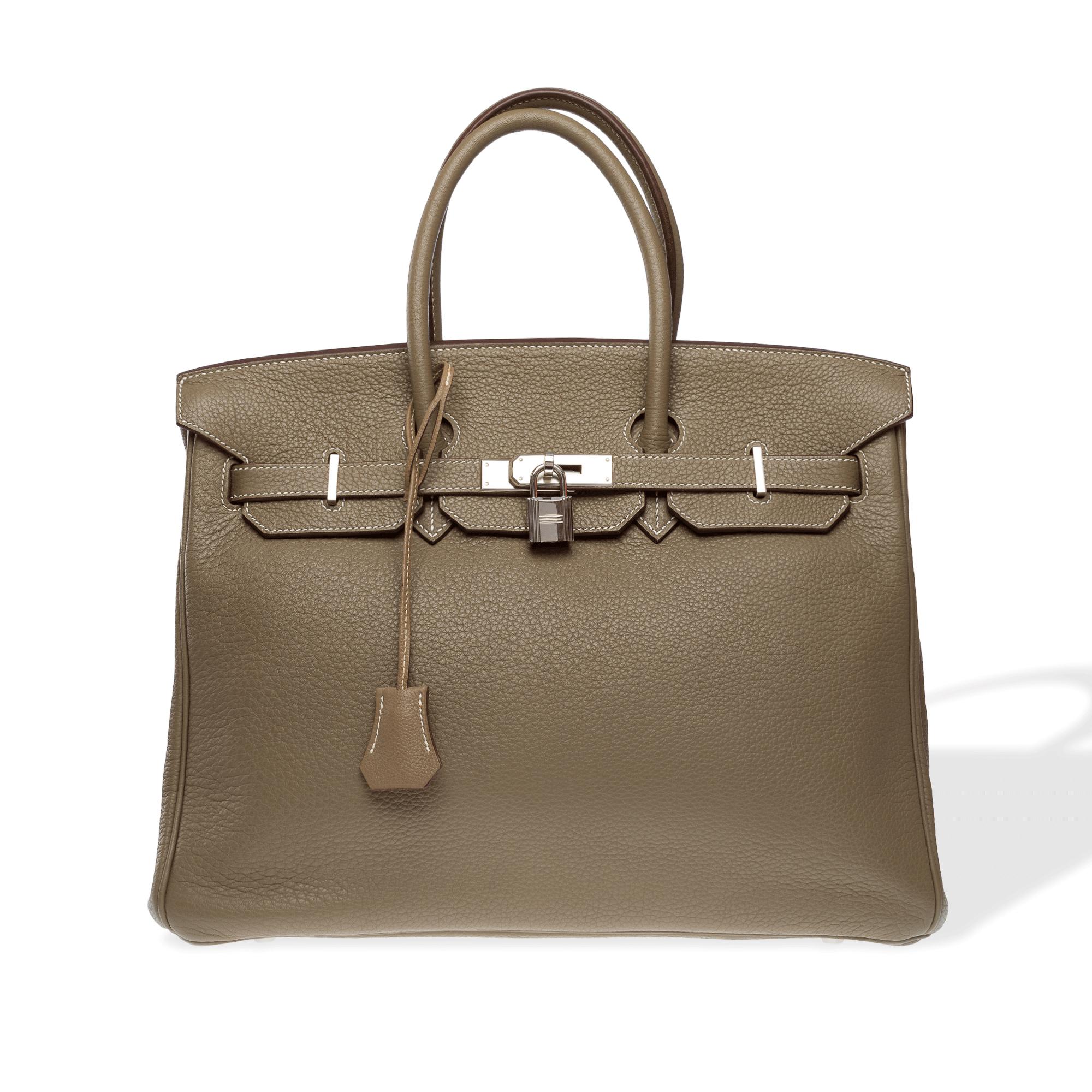 Stunning Hermes Birkin 35 handbag in taupe Taurillon Clemence calfskin with white stitching, silver Palladium metal trim, double taupe leather handles for hand carry

Flap closure
Taupe leather interior lining, one zip pocket, one flat