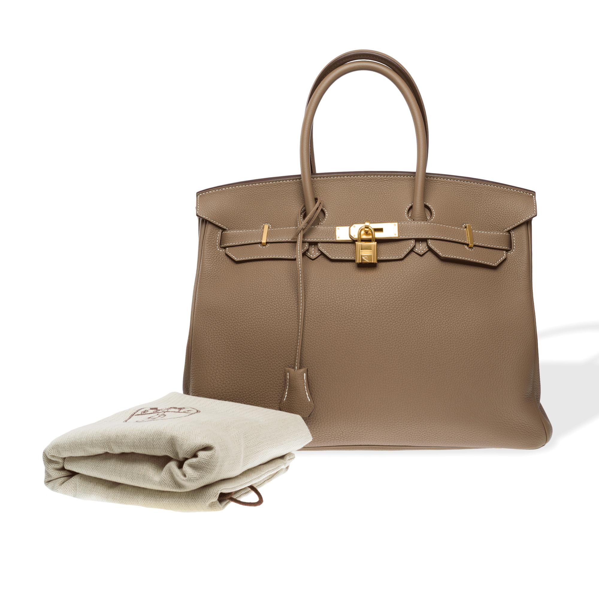 Stunning​ ​Hermes​ ​Birkin​ ​35​ ​handbag​ ​in​ ​etoupe​ ​Togo​ ​calf​ ​leather​ ​with​ ​white​ ​stitching,​ gold ​metal​ ​trim,​ ​double​ ​etoupe​ ​leather​ ​handles​ ​for​ ​hand​ ​carry

Flap​ ​closure
Etoupe​ ​leather​ ​interior​ ​lining,​ ​one​