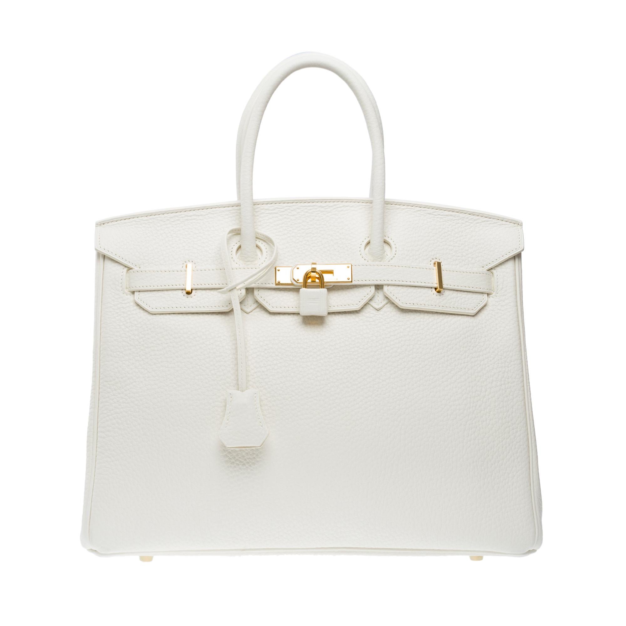 Amazing​ ​Hermes​ ​Birkin​ ​35​ ​handbag​ ​in​ ​White​ ​Taurillon​ ​Clemence​ ​leather,​ ​gold​ ​plated​ ​metal​ ​trim,​ ​double​ ​handle​ ​in​ ​white​ ​leather​ ​allowing​ ​a​ ​hand​ ​carry

Flap​ ​closure
White​ ​leather​ ​inner​ ​lining,​ ​a​