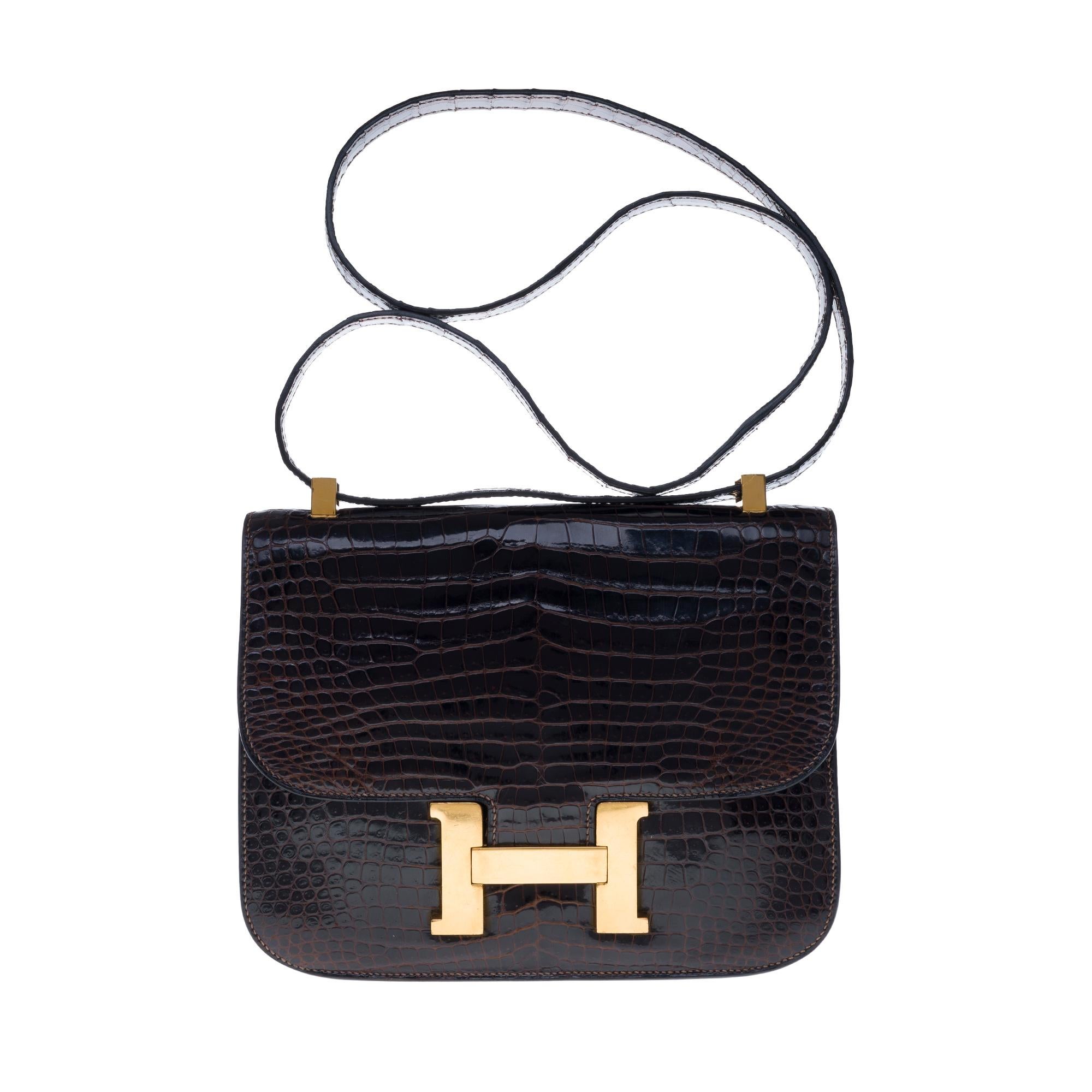 Amazing Hermes Constance handbag in brown Crocodile Porosus, gold-tone metal hardware, brown crocodile handle for hand or shoulder support.

Logo closure on flap.
A patch pocket on the back of the bag.
Lining in brown leather, a zipped pocket, a
