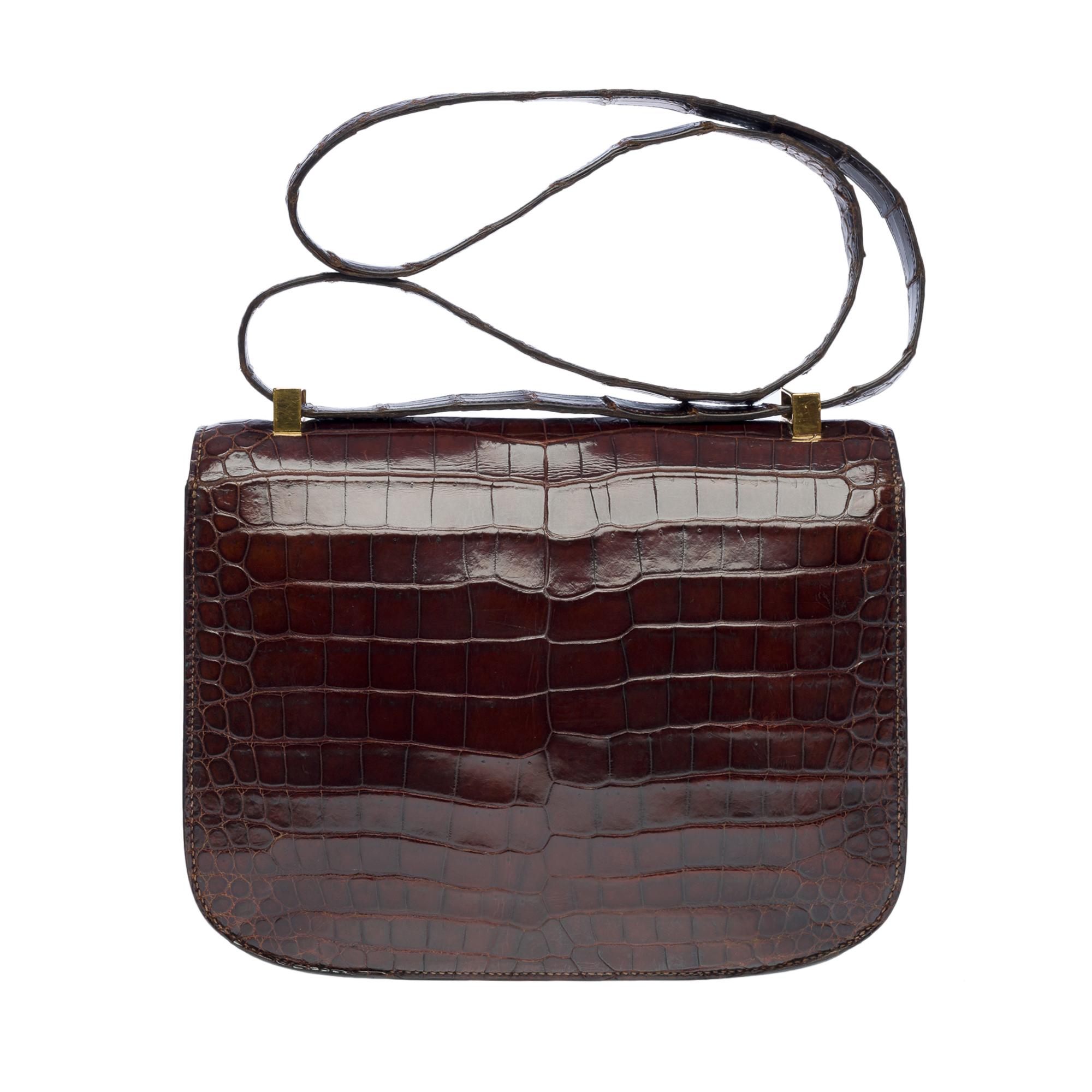 Gorgeous Hermes Constance Brown Porosus Crocodile shoulder bag, gold plated metal hardware, convertible handle in brown crocodile for hand or shoulder support

Fastener with logo on flap
A patch pocket on the back of the bag
Inner lining in brown