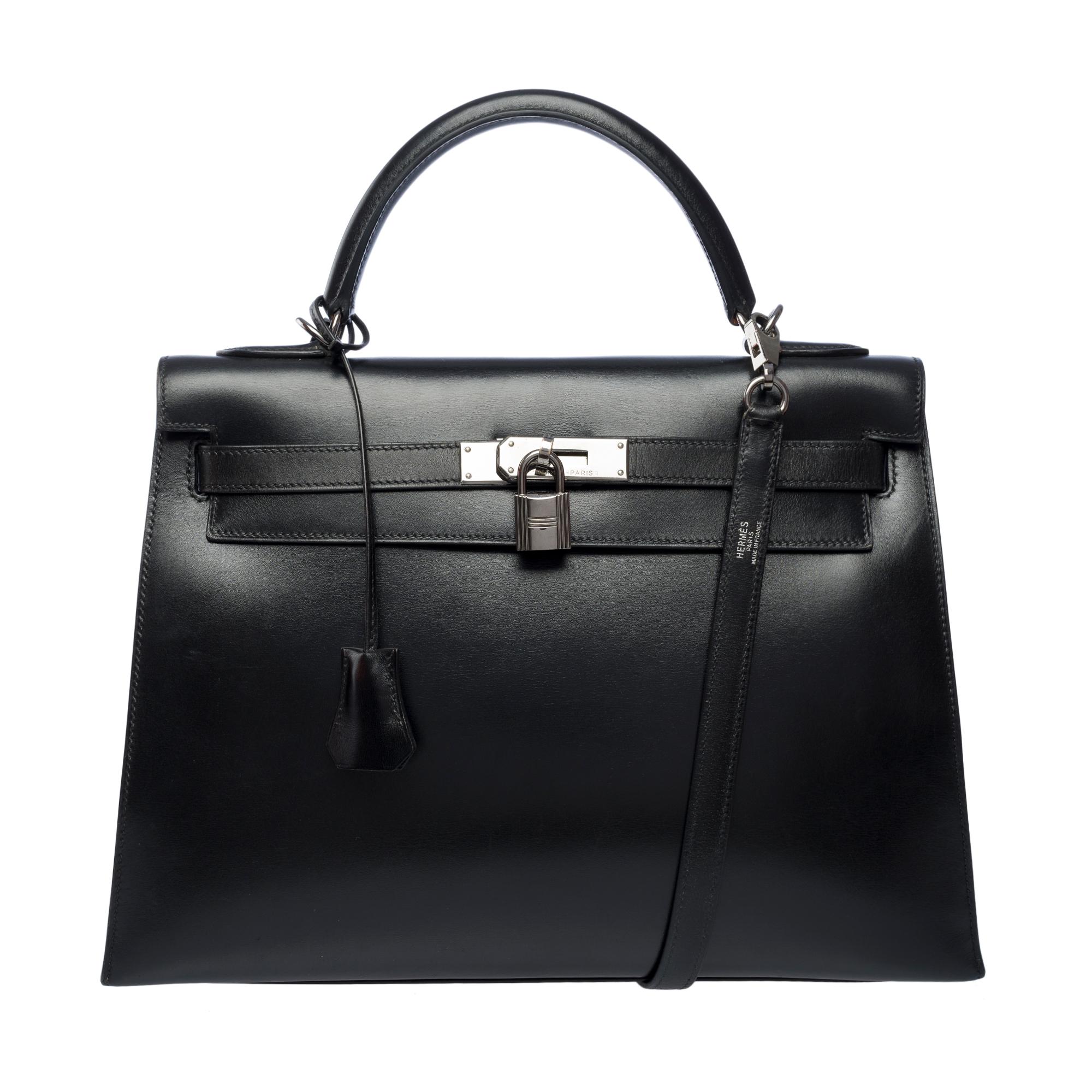 Stunning​ ​Hermes​ ​Kelly​ ​32​ ​sellier​ ​handbag​ ​strap​ ​in​ ​black​ ​box​ ​calfskin​ ​leather​ ​,​ ​palladium​ ​silver​ ​metal​ ​trim,​ ​black​ ​leather​ ​handle,​ ​removable​ ​shoulder​ ​strap​ ​in​ ​black​ ​leather​ ​for​ ​hand​ ​or​
