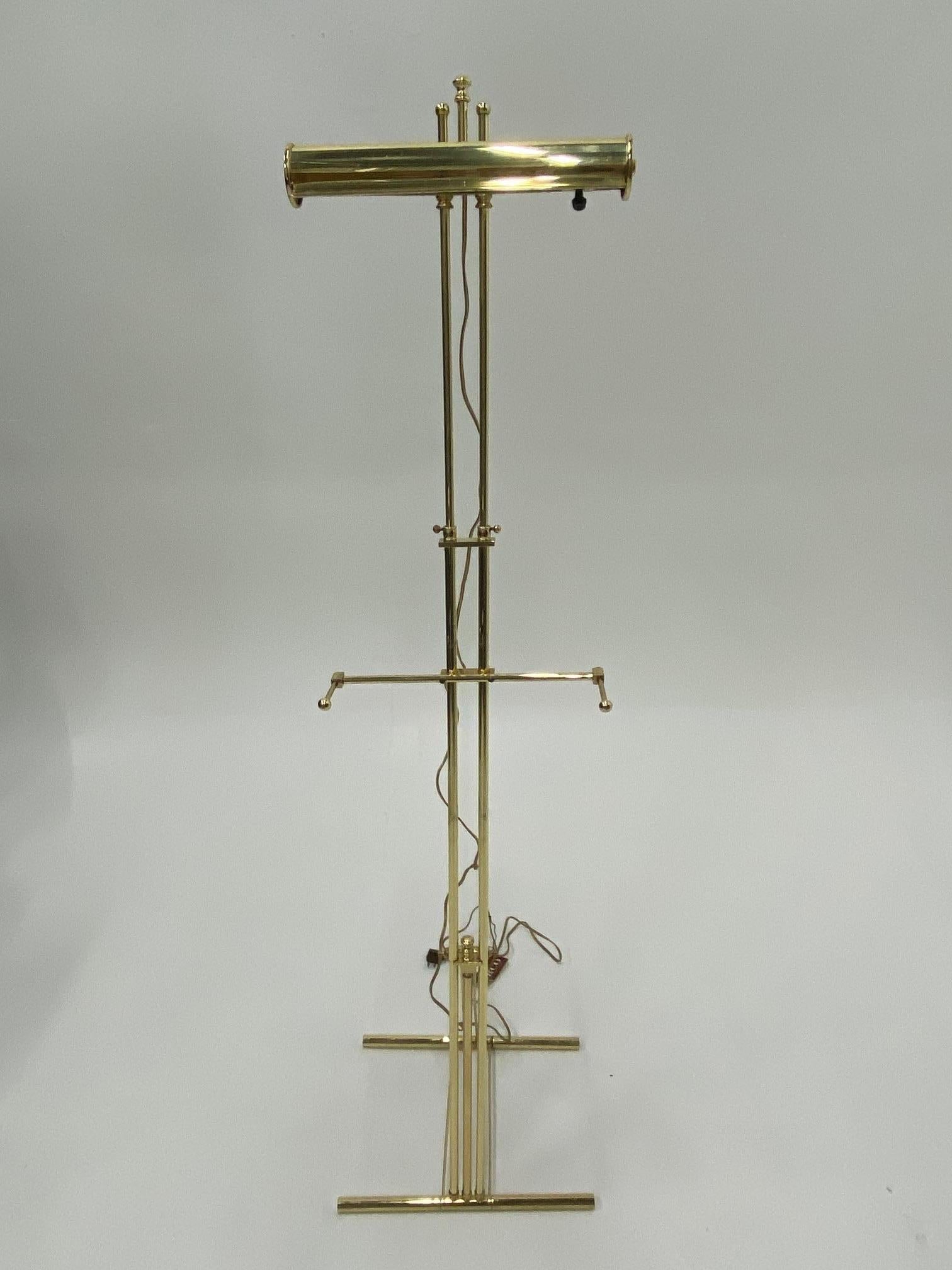 Stunning solid brass adjustable easel with picture light by Herco Lighting, a division of Reed & Barton, a superior designer of brass lighting since 1924. High gloss brass with high baked lacquer.