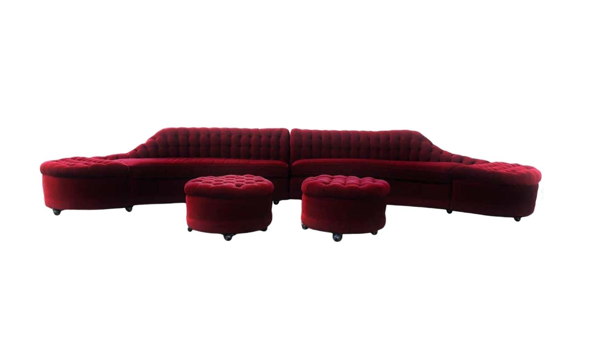 Vintage Hollywood Regency an extra long two-part sofa with a deep tufted back. The sofa splits in the centre, each side has a single seat cushion with rounded outer edge on an upholstered base, the extension has a tufted top and also has a curved