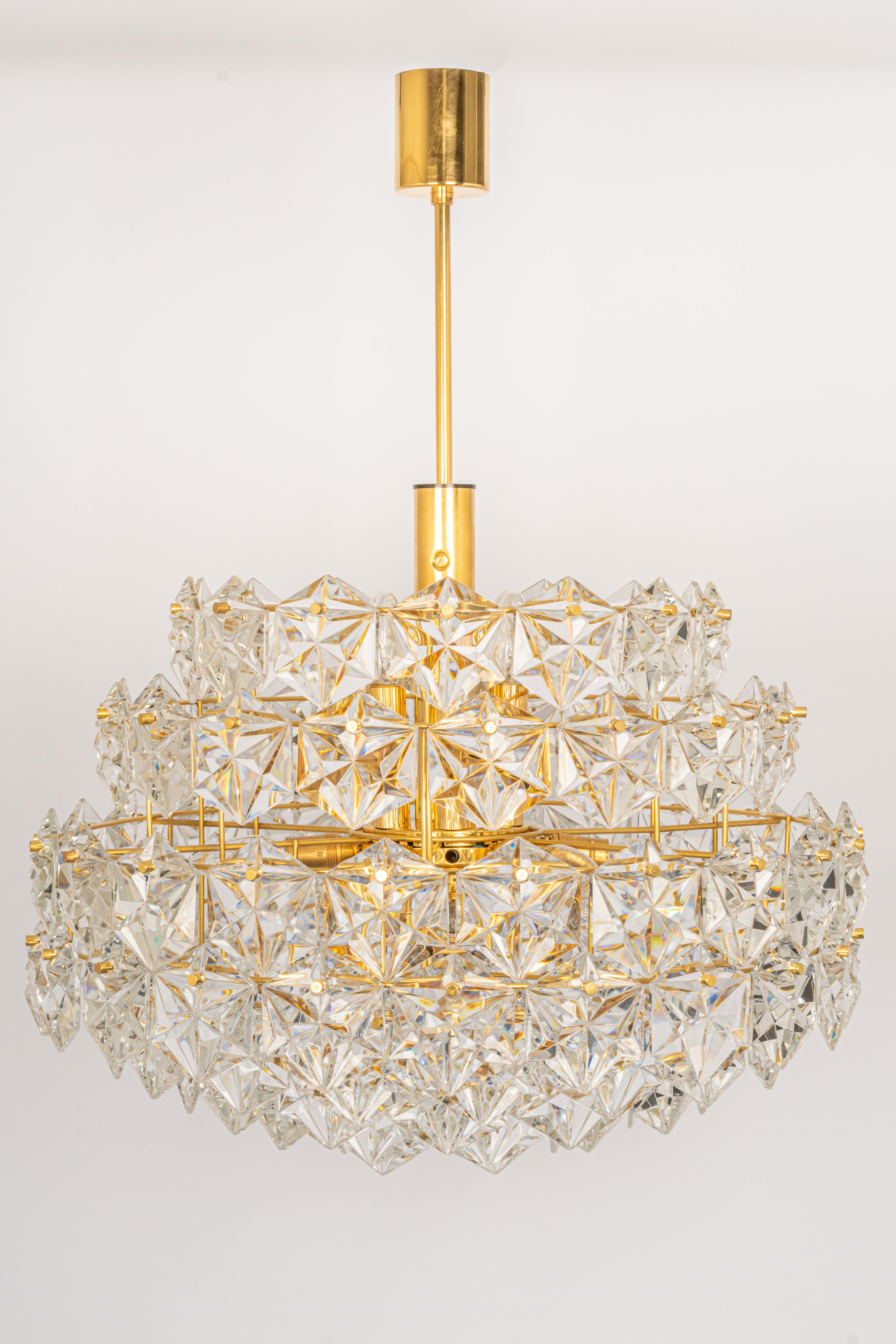 A stunning eight-tier chandelier by Kinkeldey, Germany, was manufactured in circa 1970-1979. A handmade and high-quality piece. The ceiling fixture and the frame are made of brass and have eight rings with lots of facetted crystal glass