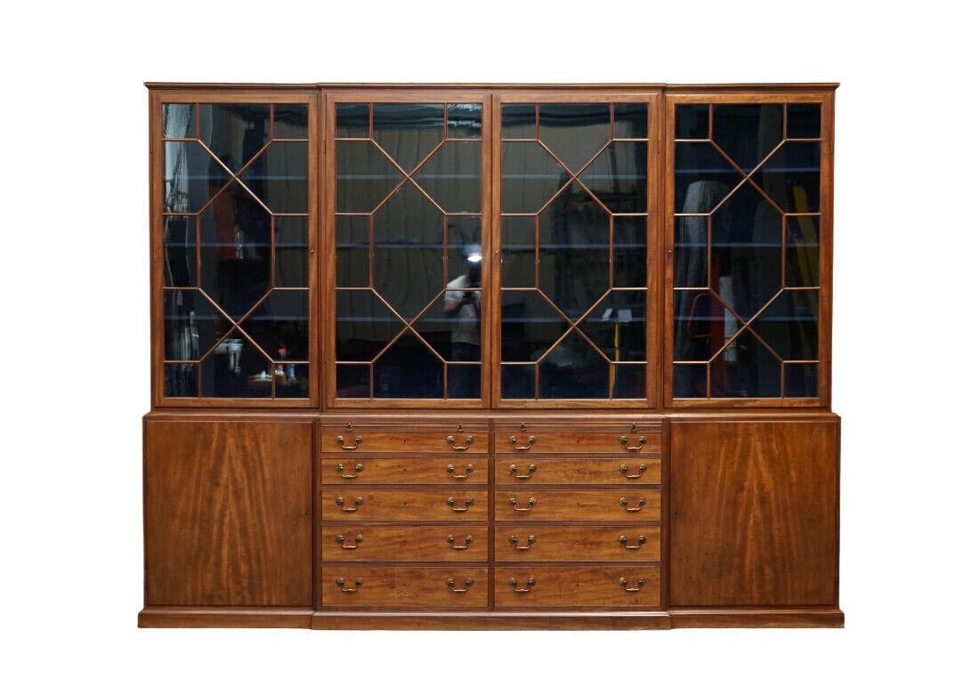 We are excited to present this stunning, very well-made flamed mahogany large Astral Glazed library breakfront bookcase.

You can see by how it is all put together that its first owner gave a significant budget to the cabinetmaker that made this