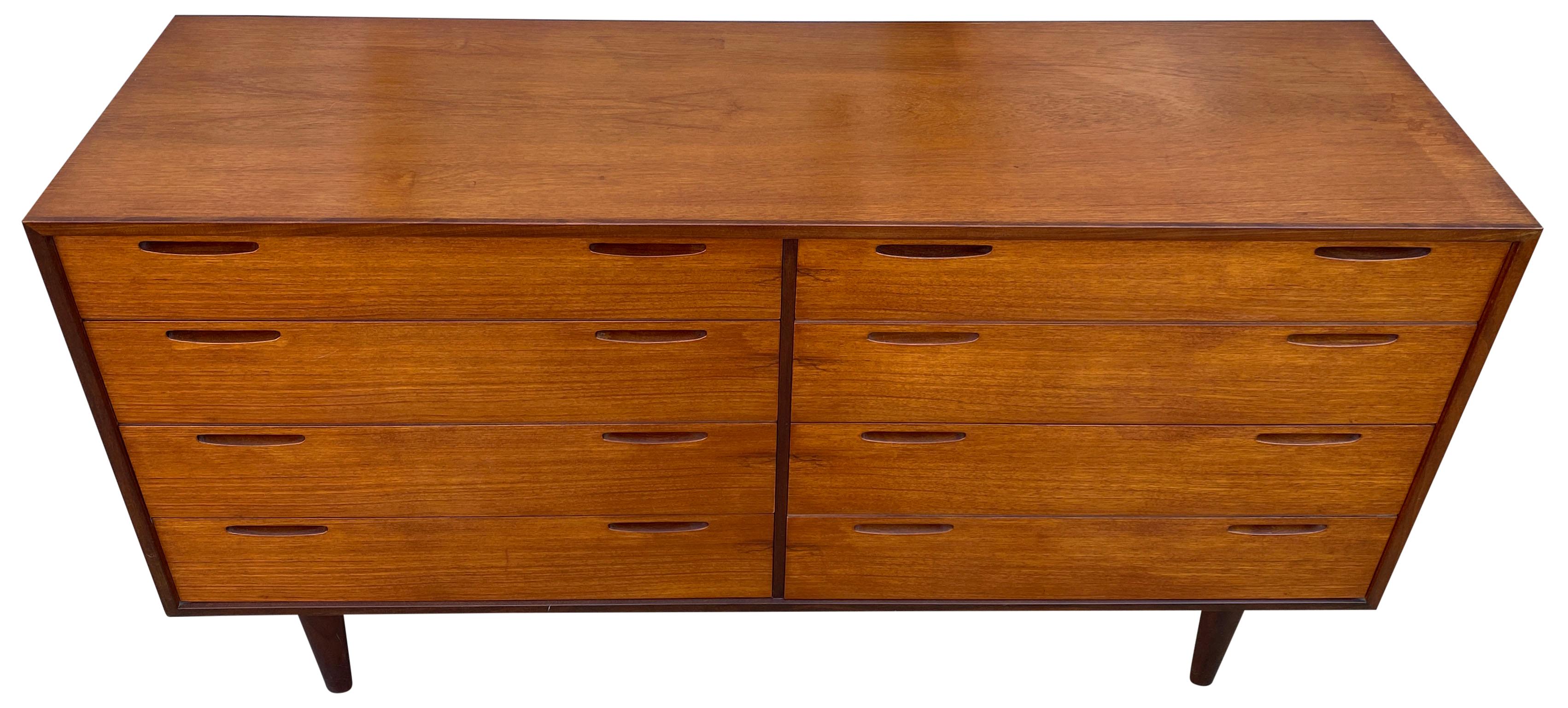 Beautiful 8-drawer dresser credenza designed by Ib Kofod-Larsen and manufactured by J. Clausen Brande Møbelfabrik, Denmark, 1960. Very high quality Scandinavian design, superb finished all around and even the teak wooden back. Nice details are the