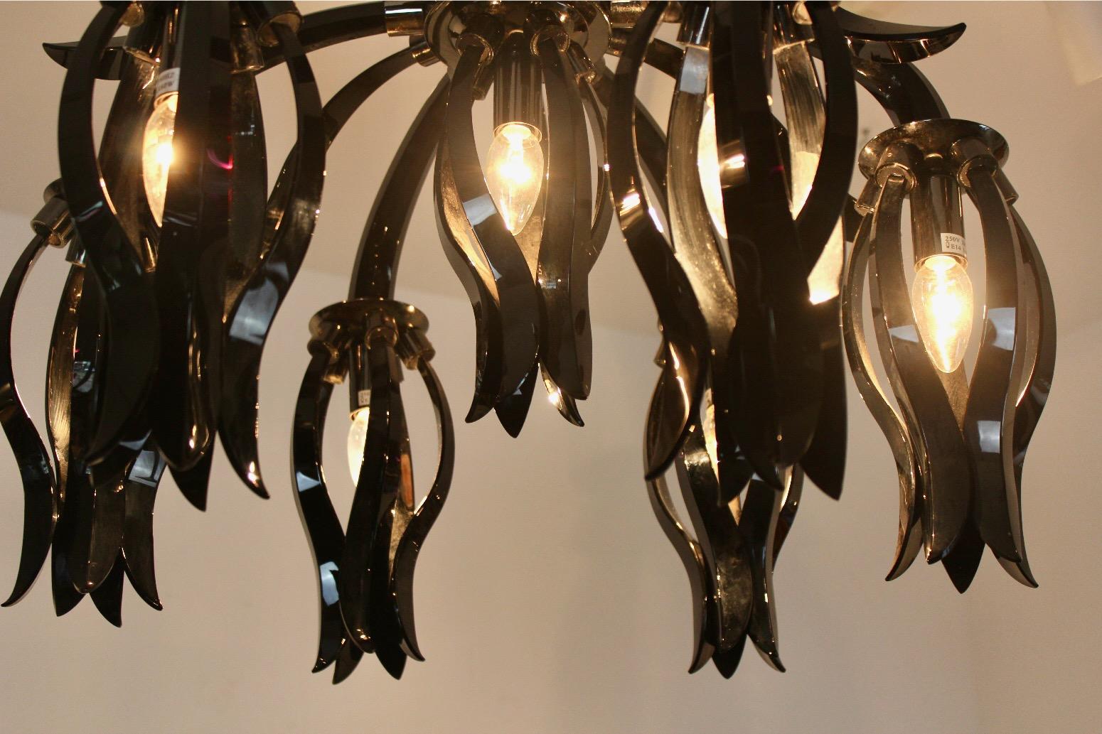 The Black Glass Chandelier by Barovier & Toso is a stunning piece of lighting art that showcases the Venetian glass-making skills of the Barovier & Toso brand. The chandelier features a cascade of black glass pieces that hang from a glass frame,