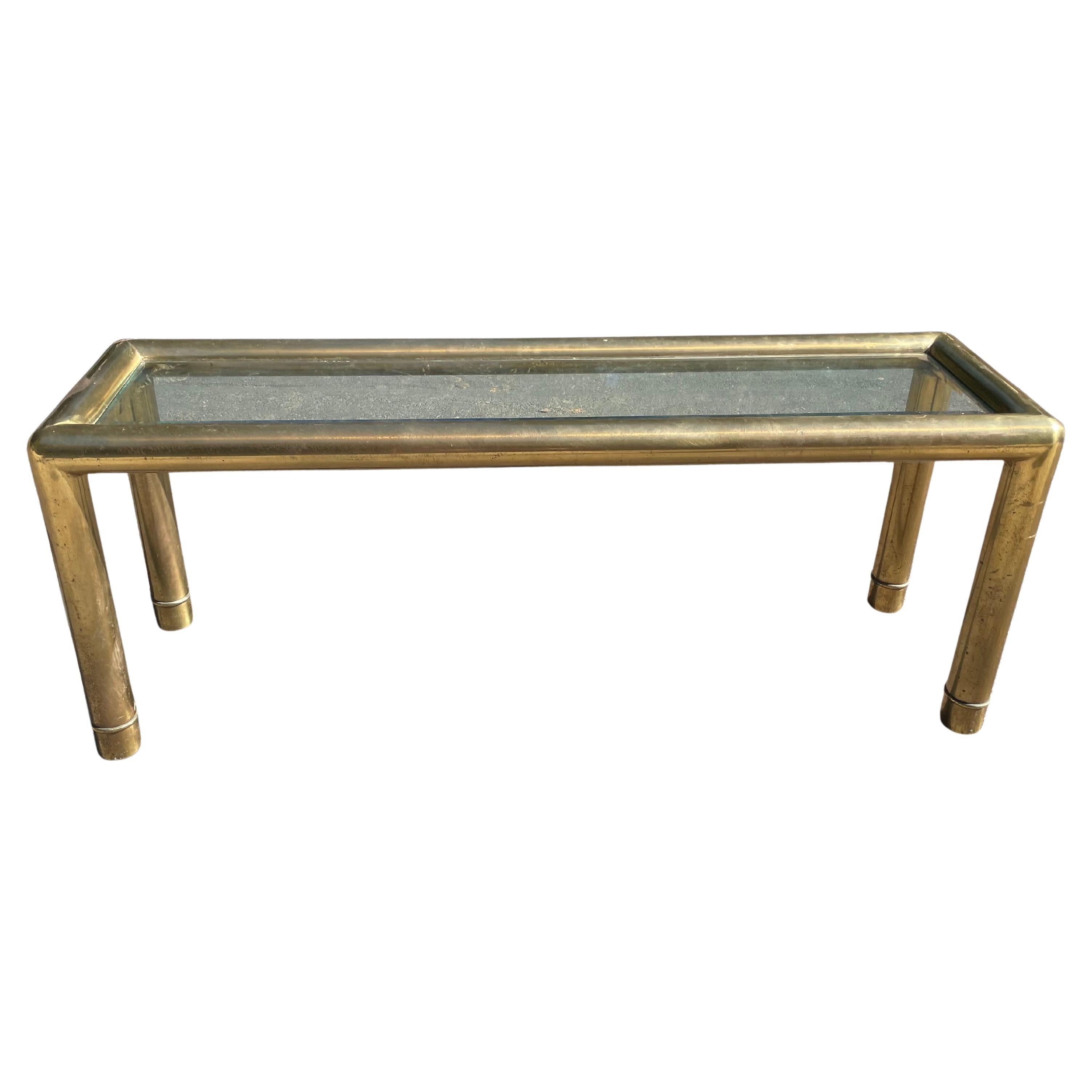 Amazing tubular brass console table by Mastercraft, circa 1970s. This table features a clad patinated brass body with glass top

Great mid-century design. Definitely a statement piece.

Height: 25.5 inches
Length 65 inches
Depth: 18 inches

Good