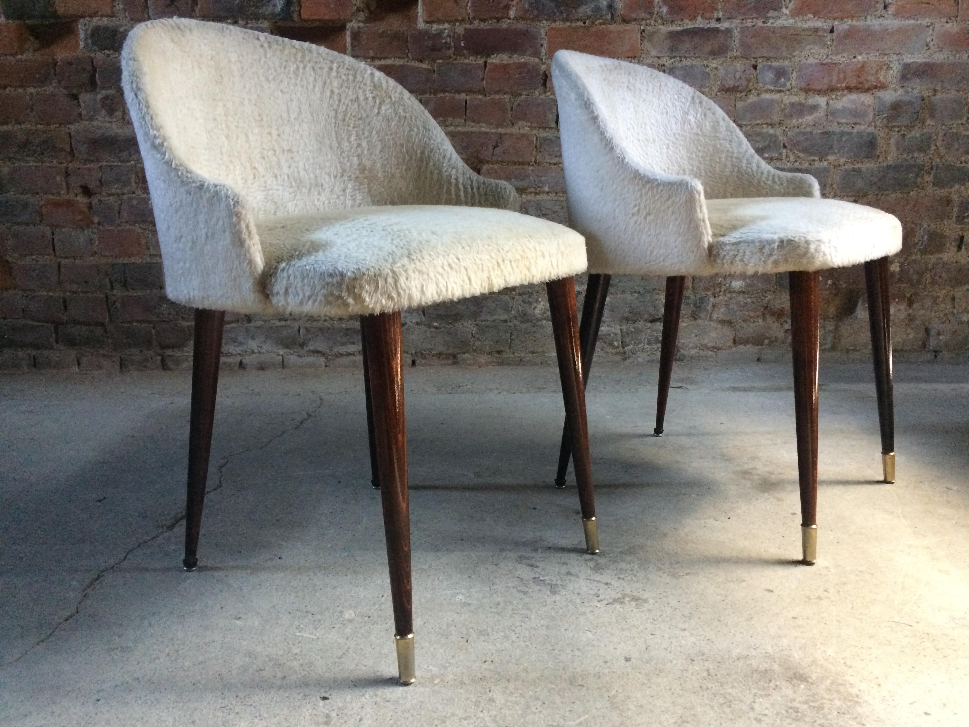 Stunning Italian cocktail chairs pair of ladies 1950s midcentury vintage

A fabulous pair of ever so dainty 1950s Italian cocktail chairs in the manner of Gin Ponti, upholstered in original faux fur fabric sitting on tall and elegant tapering legs