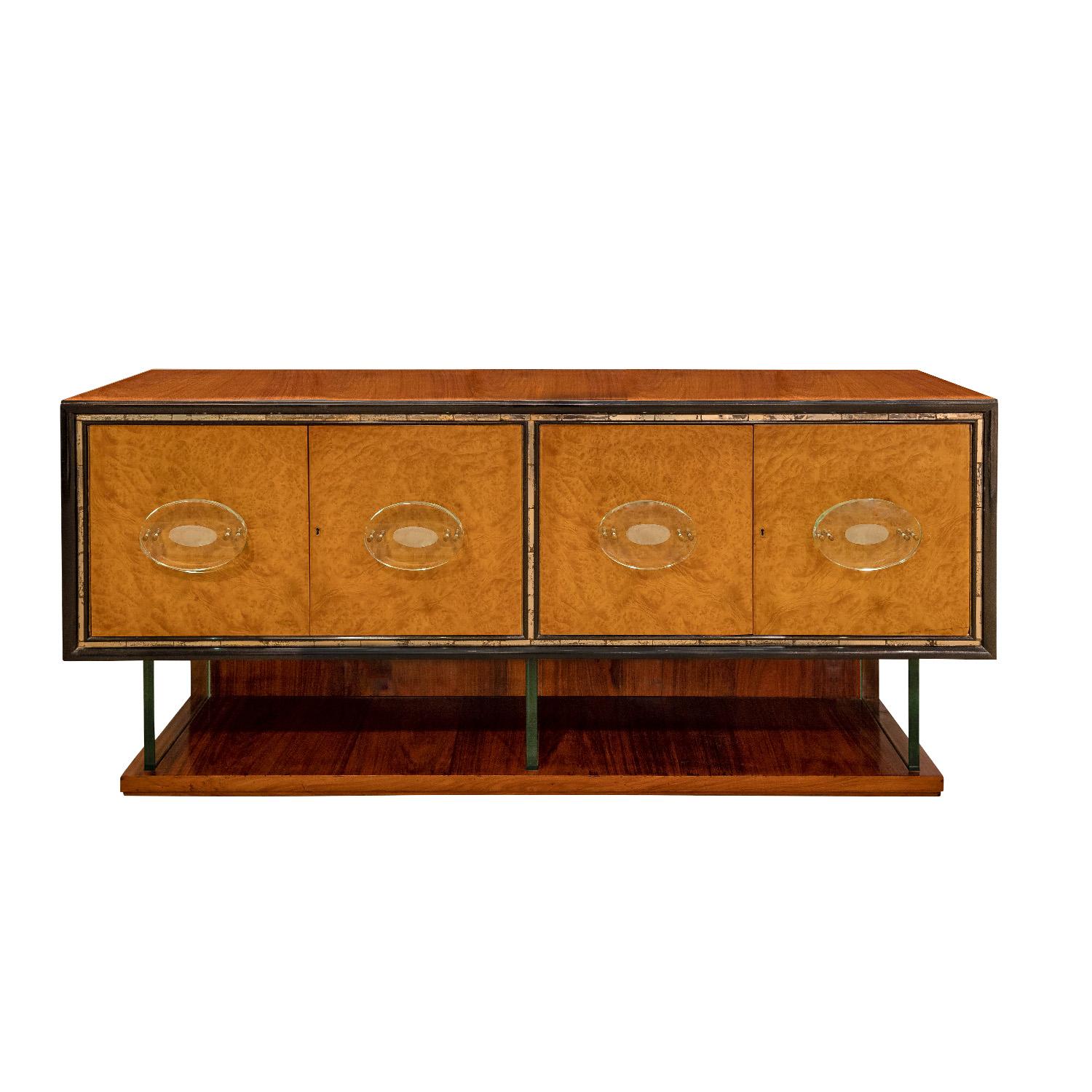Beautifully crafted credenza in Italian walnut with vertical glass slab supports and glass handles by Fontana Arte on the bookmatched burl doors with brass accents, Italian 1950s. There is antique mirror trim around the doors. This piece is