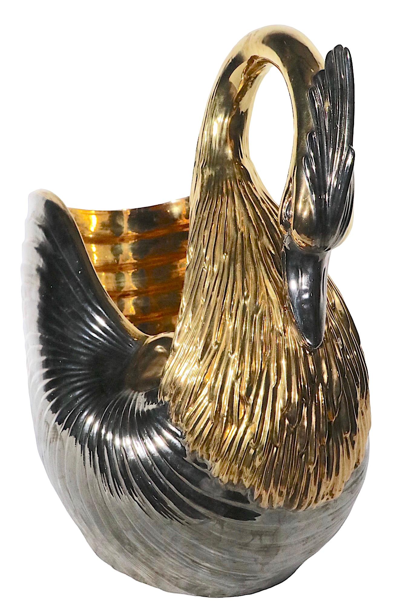 Stunning porcelain swan, executed in brilliant gold luster and dark silver glazes. This impressive statement piece will surely complete any interior space it inhabits. Made in Italy, probably Venetian, circa 1970s. The crown of the swan shows an old