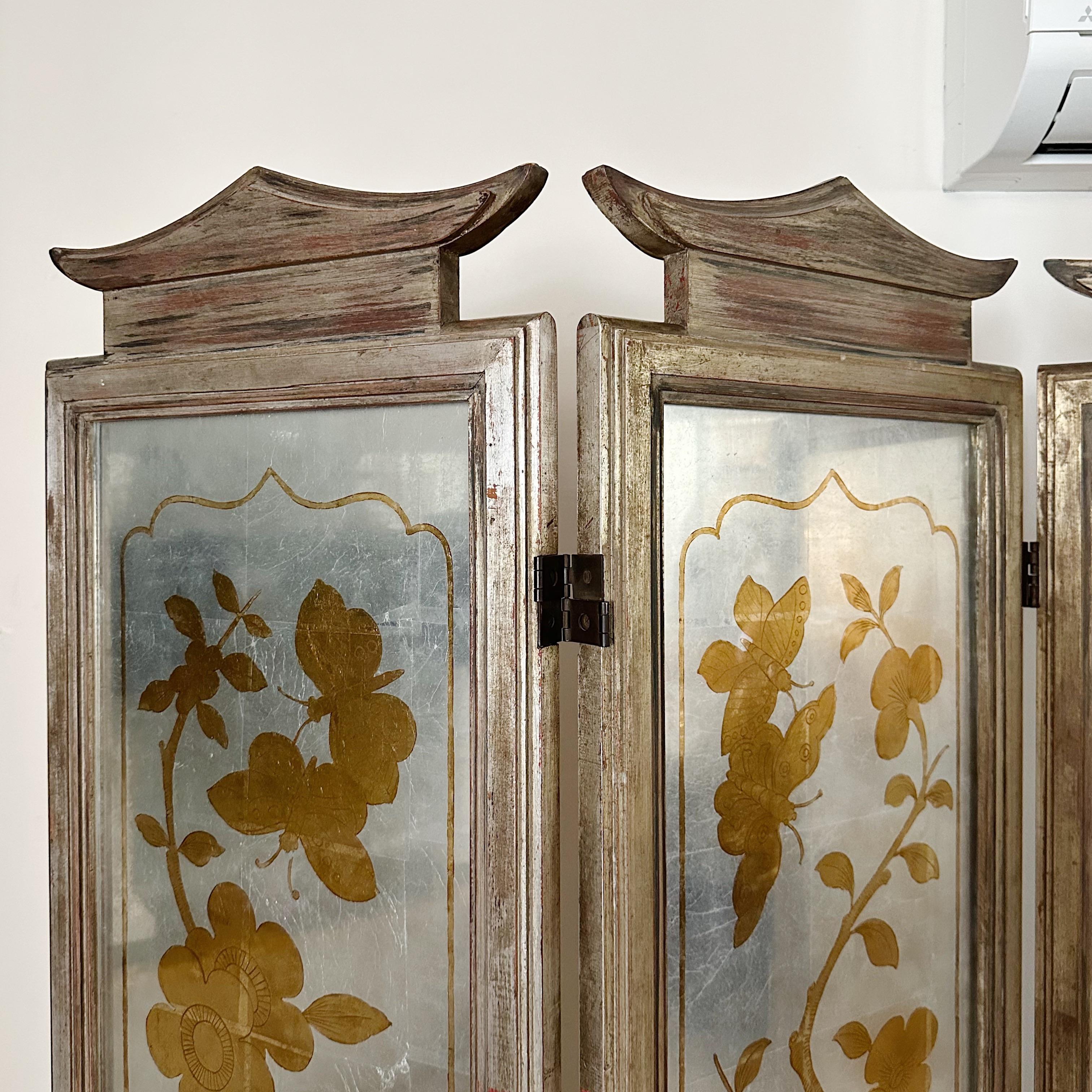 This magnificent James Mont screen room divider , created in 1950, is a stunning example of Mont's Chinese-modern style. Each of the glass panels is hand-finished with a verre eglomise design in gold metal leaf, backed with a silver metal leaf. The