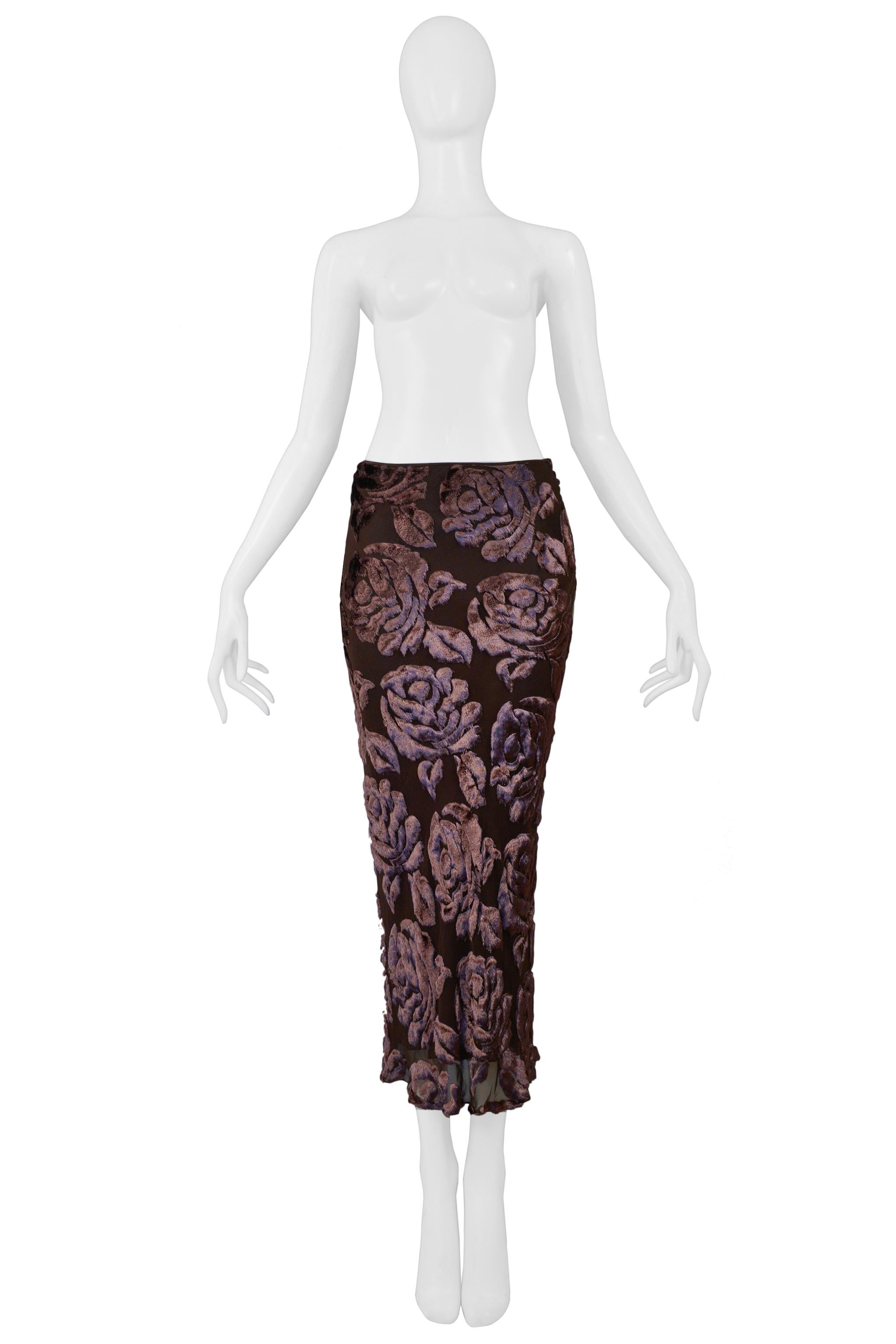 Resurrection is excited to offer a vintage John Galliano brown floral burnout velvet skirt featuring bias cut, signature Galliano side button closure, and above ankle length.

John Galliano
Size: 36
Viscose and Silk  
Lining 100% Silk 
Excellent