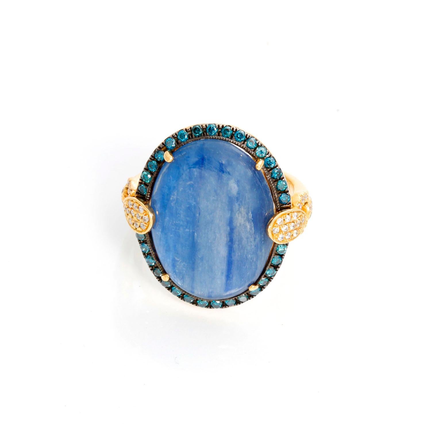 Stunning 18k Yellow Gold, Kyanite, Blue Diamond, and White Diamond Ring Sz. 7 -  This stunning ring features an oval kyanite (13.21 ct.) cabochon bordered by blue diamonds (0.38ct.) with accenting white diamonds (0.18ct.) set in 18k yellow gold.