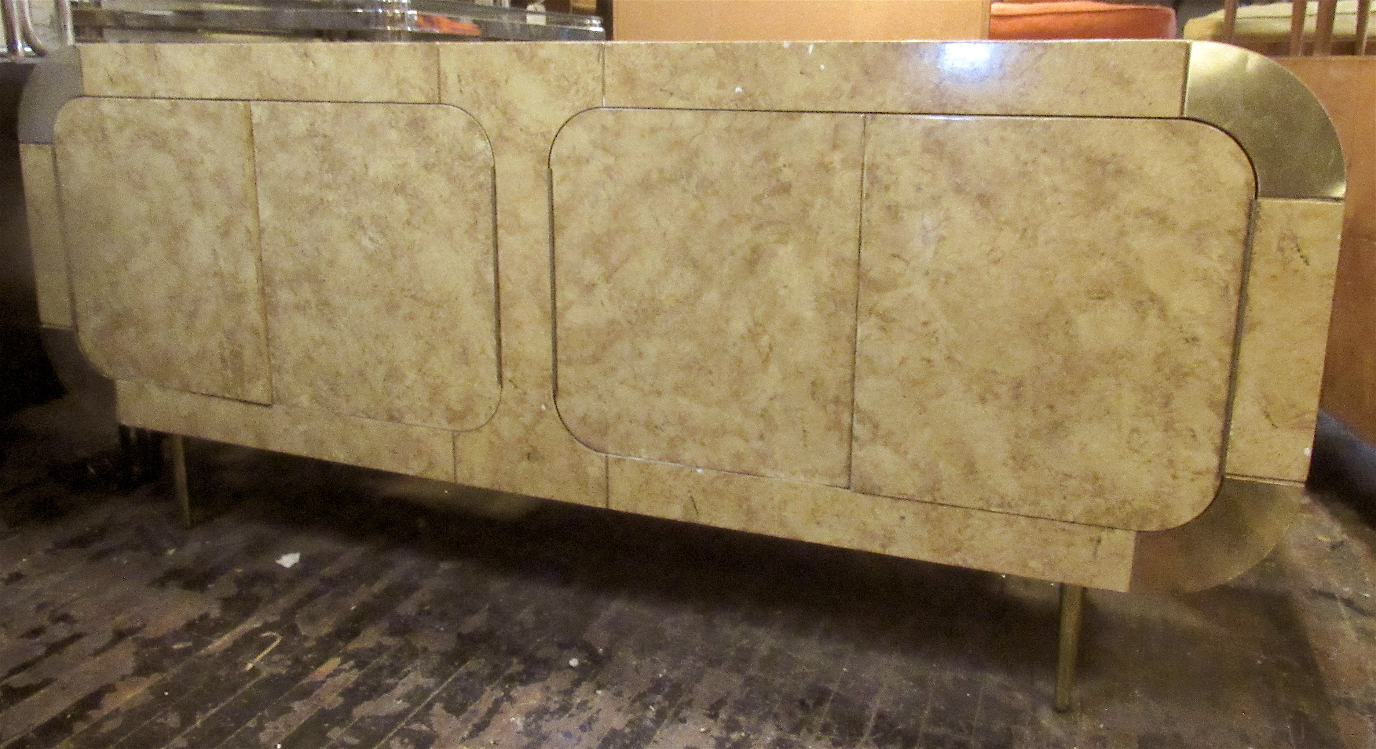 Mid-century modern rounded cabinet in a burl colored lacquered finish. Accented with polished brass corners and legs. Two large cabinets, great for bar or living room storage.
Please confirm location NY or NJ