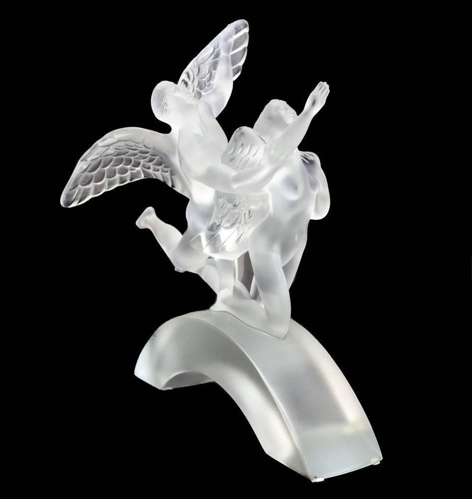 A stunning Lalique France crystal art glass figurine, Eden Celebration 2000, limited edition of 99, original box. The figurine beautifully depicts a male and female angel in a dynamic kneeling pose. Engraved 