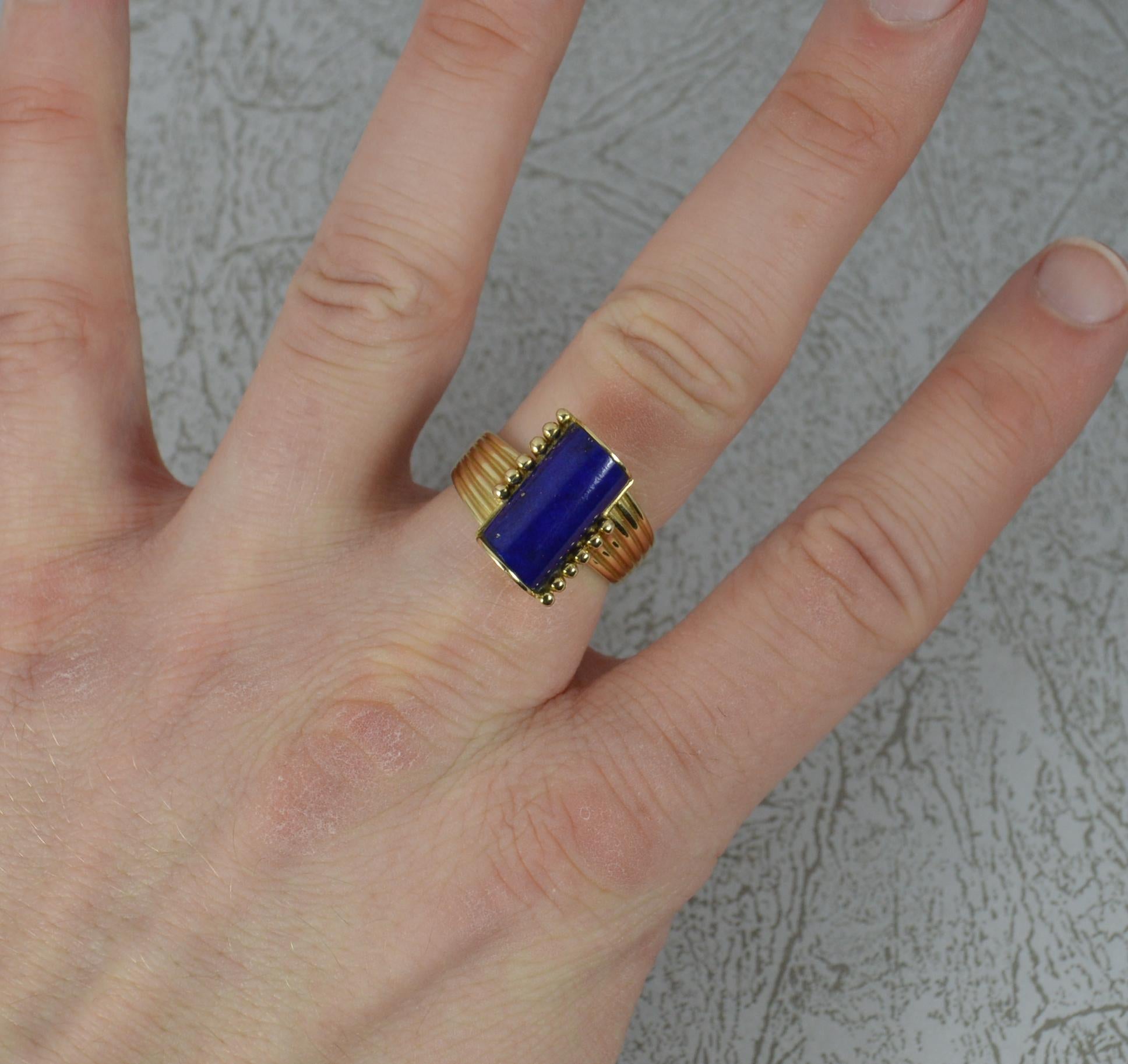 A very stylish retro solitaire ring.
Solid 14 carat yellow gold example.
Designed with a single cylinder shaped lapis lazuli stone. 7mm x 14mm. On twist.
Protruding 9mm off the finger.

CONDITION ; Very good. Clean and strong band. Securely set