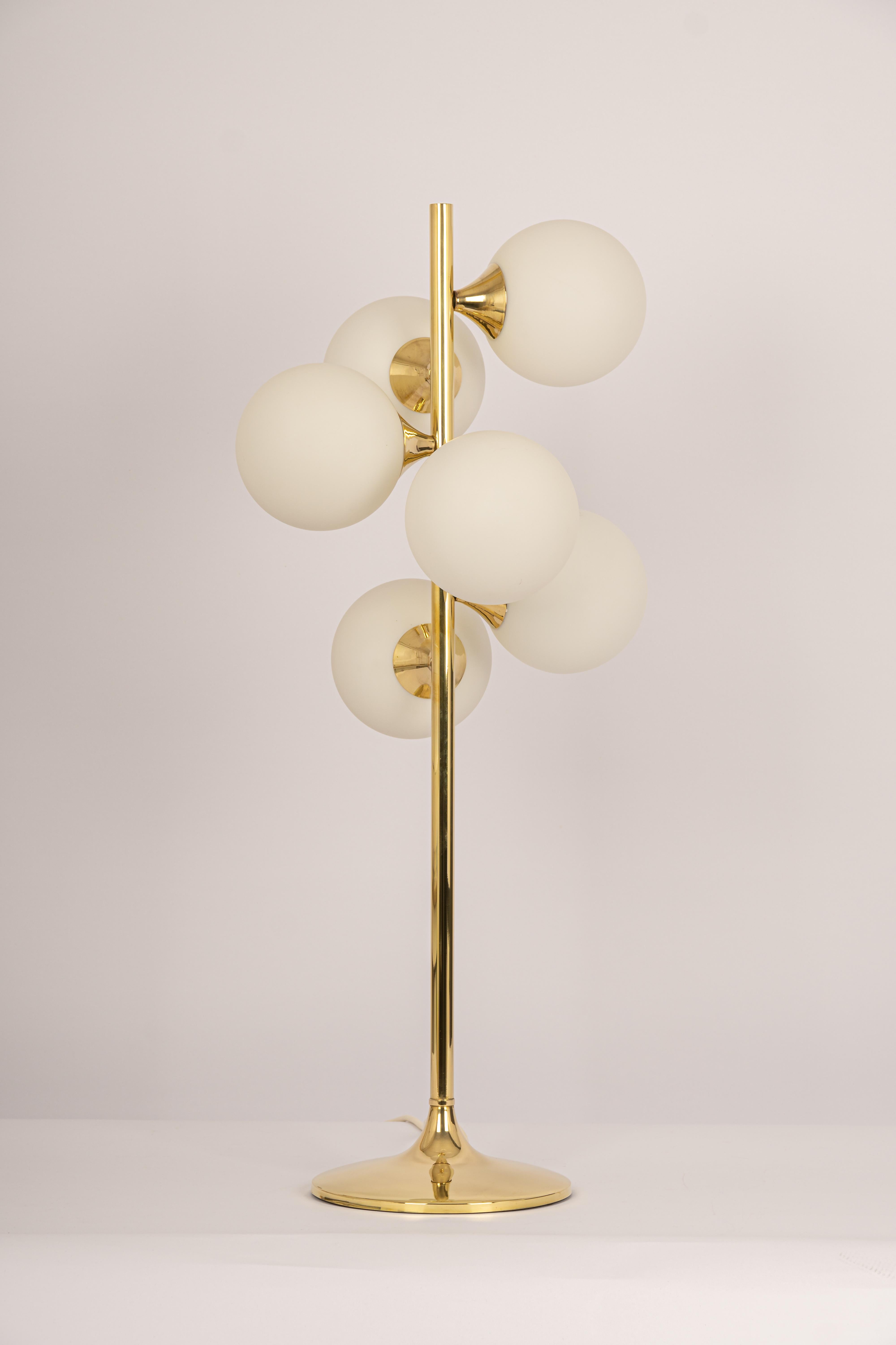 Stunning large brass table or floor lamp by Kaiser, Germany, 1970s
It’s composed of 6 Opal glass pieces on a brass frame.

High quality and in very good condition. Cleaned, well-wired and ready to use. 

Each table lamp requires 6 x E14 Small