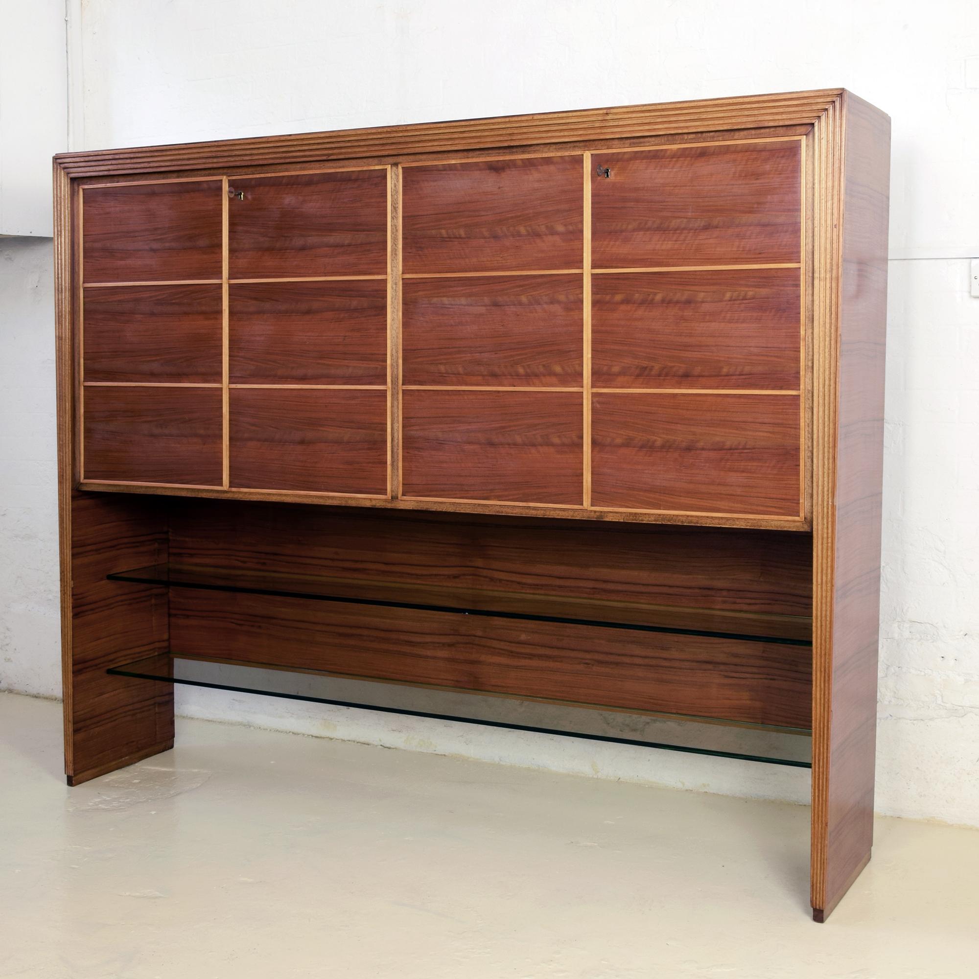 In the style of the early, pre-war, work of the Italian designers Gio Ponti, Paolo Buffa, Osvaldo Borsani.

Made by Mobili Saragoni, MIlan,

Very large and impressive cabinet, late 1930s

Veneered and solid wood with two heavy glass lower