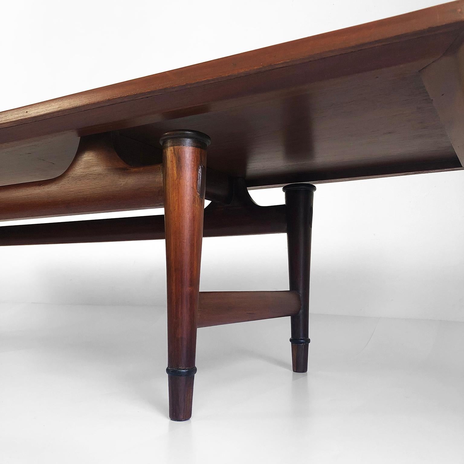 We offer this stunning large coffee table designed by Frank Kyle, circa 1950. The table has the most important characteristics and design lines of Frank Kyle such as the mixture of mahogany and tropical woods. A wonderful piece by one of the most