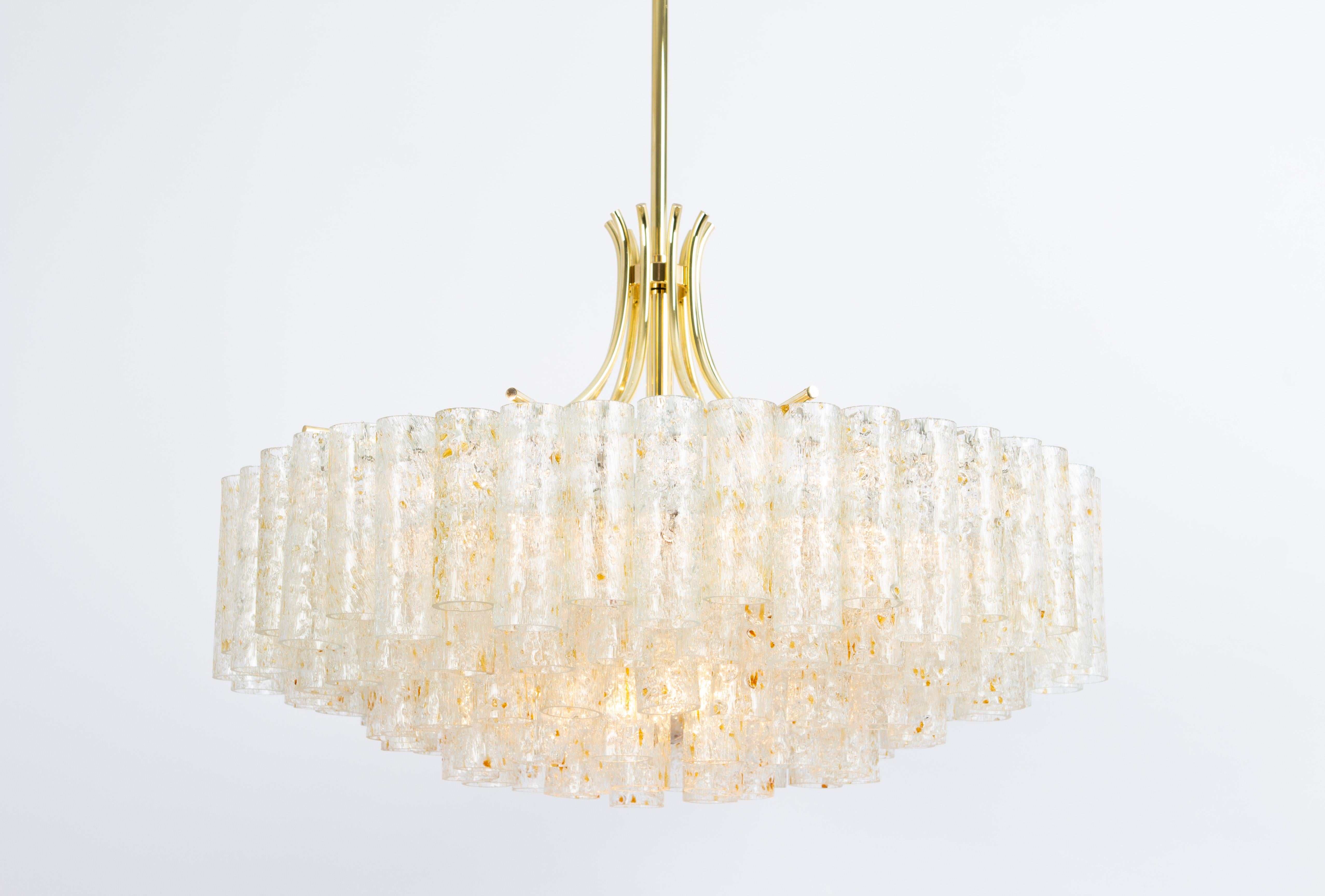 Stunning Five-tier midcentury chandelier by Doria, Germany, manufactured circa 1960-1969. Five rings of Murano glass cylinders( with gold color flakes)  suspended from a fixture.
Wonderful light effect.
Sockets: 7 x E27 standard bulbs (up to 80 W