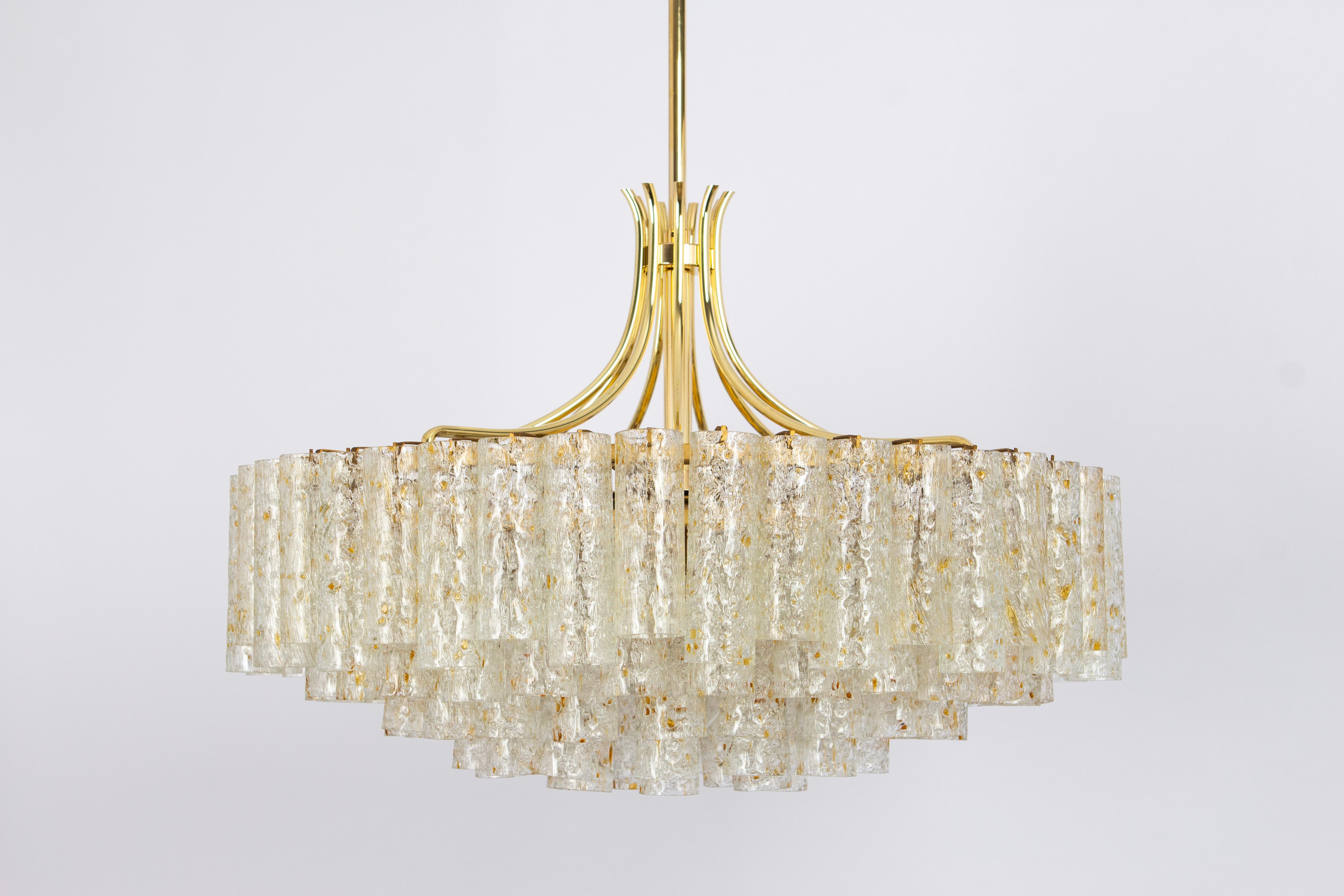 Stunning Five-tier midcentury chandelier by Doria, Germany, manufactured circa 1960-1969. Five rings of Murano glass cylinders( with gold color flakes)  suspended from a fixture.
Wonderful light effect.
Sockets: 7 x E27 standard bulbs (up to 80 W