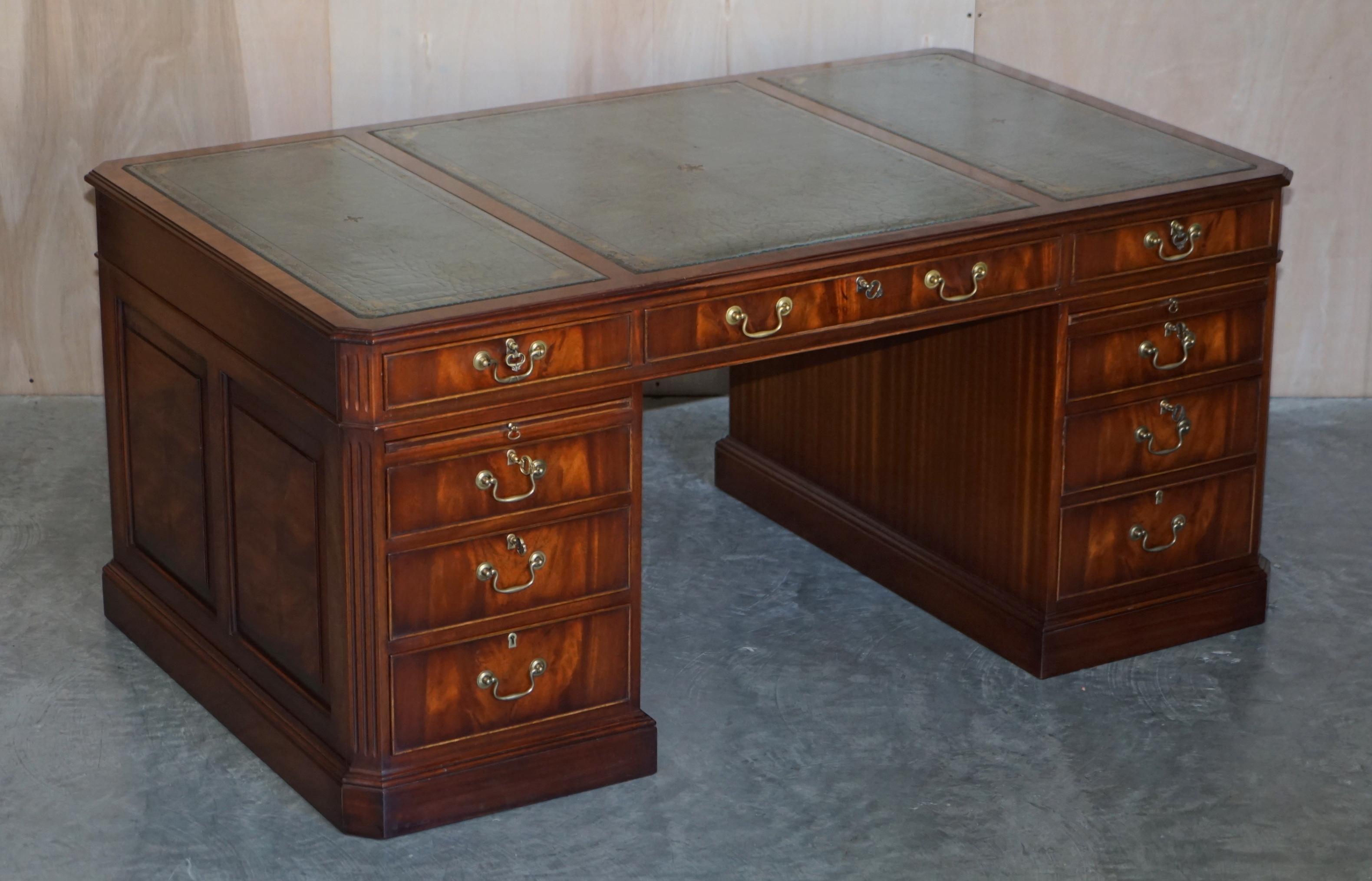 We are delighted to offer for sale this lovely vintage flamed mahogany large twin pedestal partner desk with Regency blue leather top and twin “butler” slip serving trays.

A very good looking and nicely formed desk, its much larger than normal,