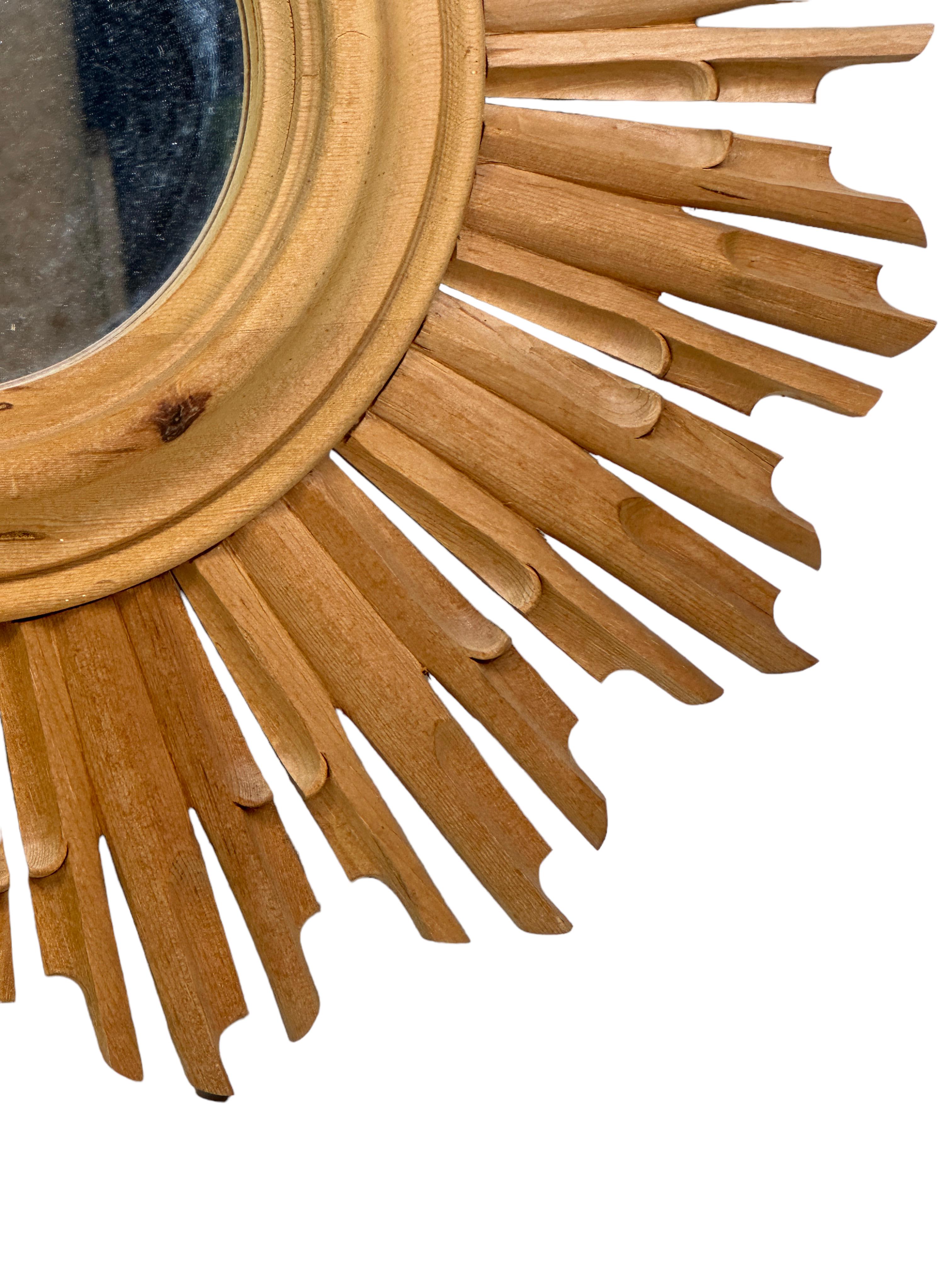 A gorgeous petite starburst sunburst mirror. Made of wood. It measures approximate 22