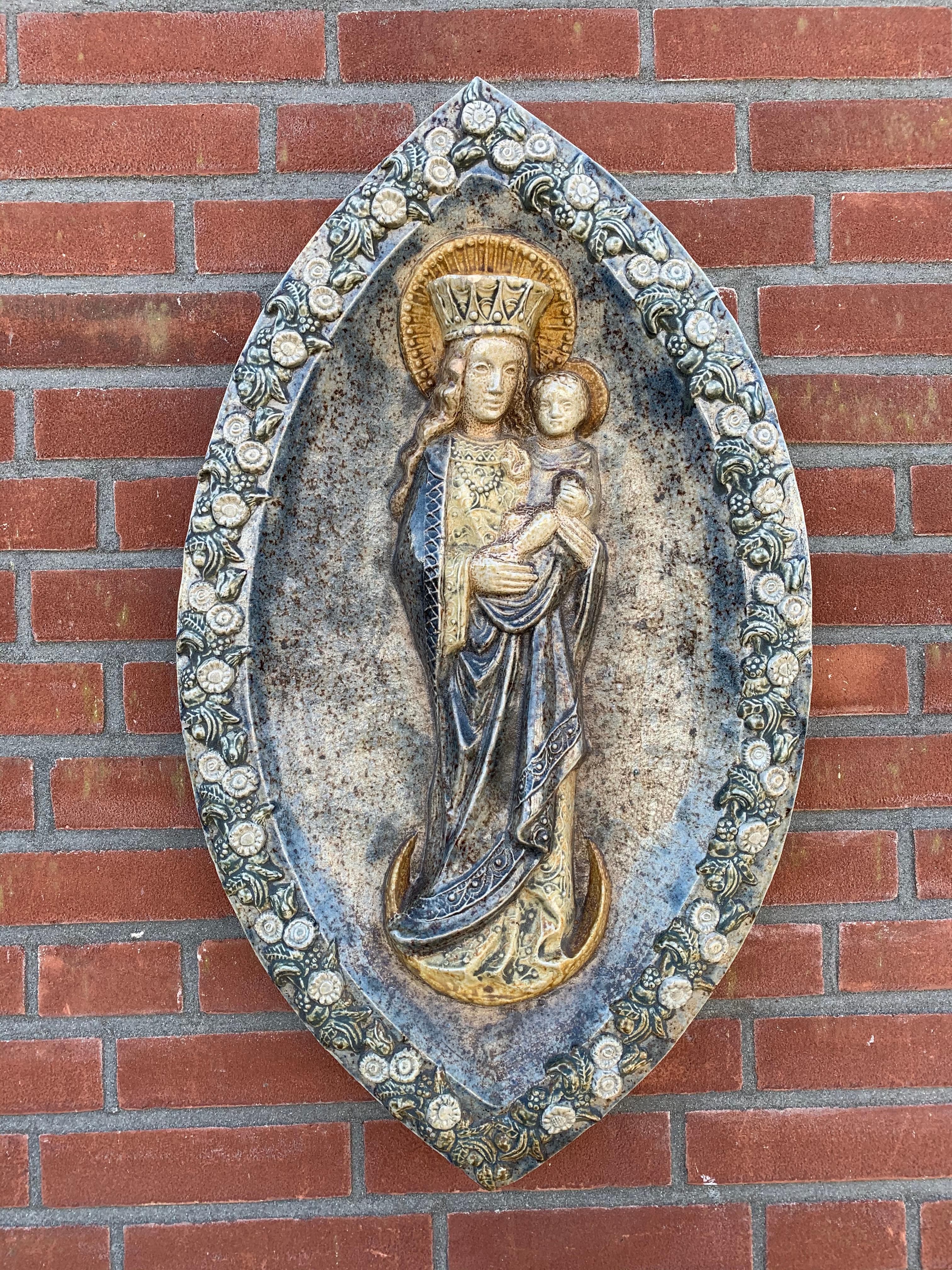 Unique wall plaque depicting Madonna and Child.

Over the past decade or two we have seen and sold many works of religious art, but we never before had the pleasure of offering such a unique and all handcrafted piece out of glazed terracotta. To