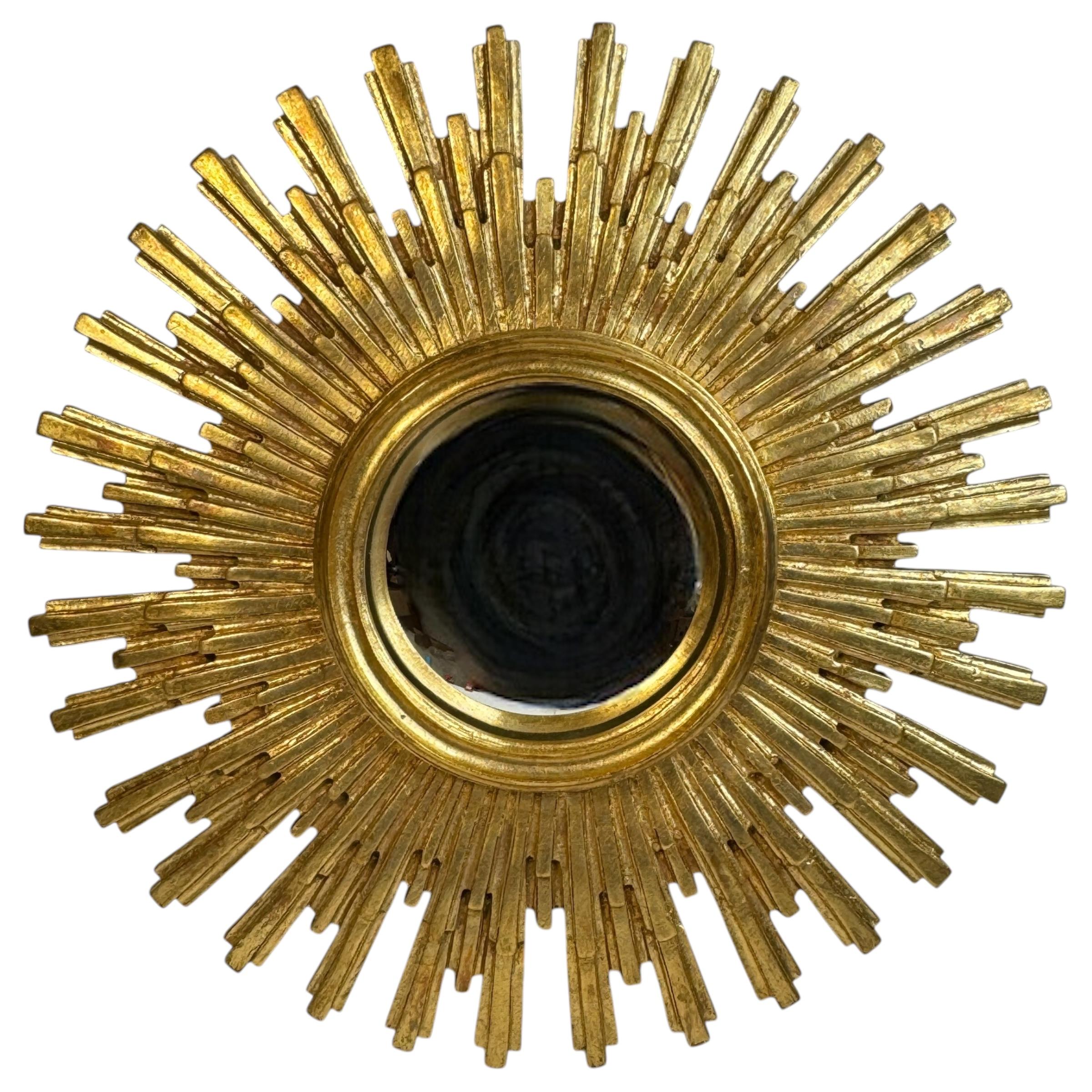 A gorgeous extraordinary starburst sunburst convex mirror. Made of gilded resin. No chips, no cracks, no repairs. It measures approximate: 22