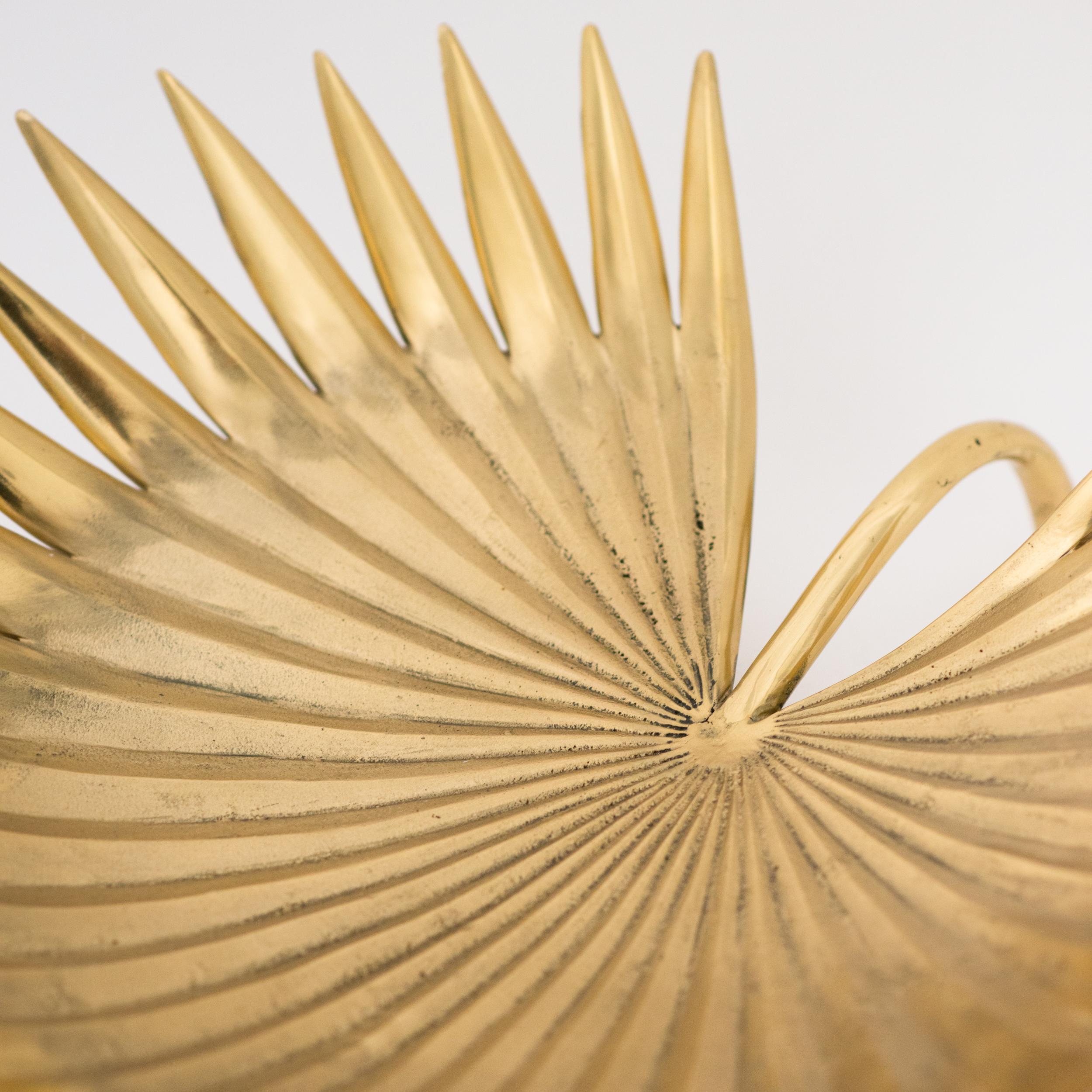 Stunning large hand-cast sculptural brass palm leaf with a mixed polished and raw finish.

Slight variations in the patina and polished finishes, patterns and sizes are characteristics of such original handmade creations. These characteristics