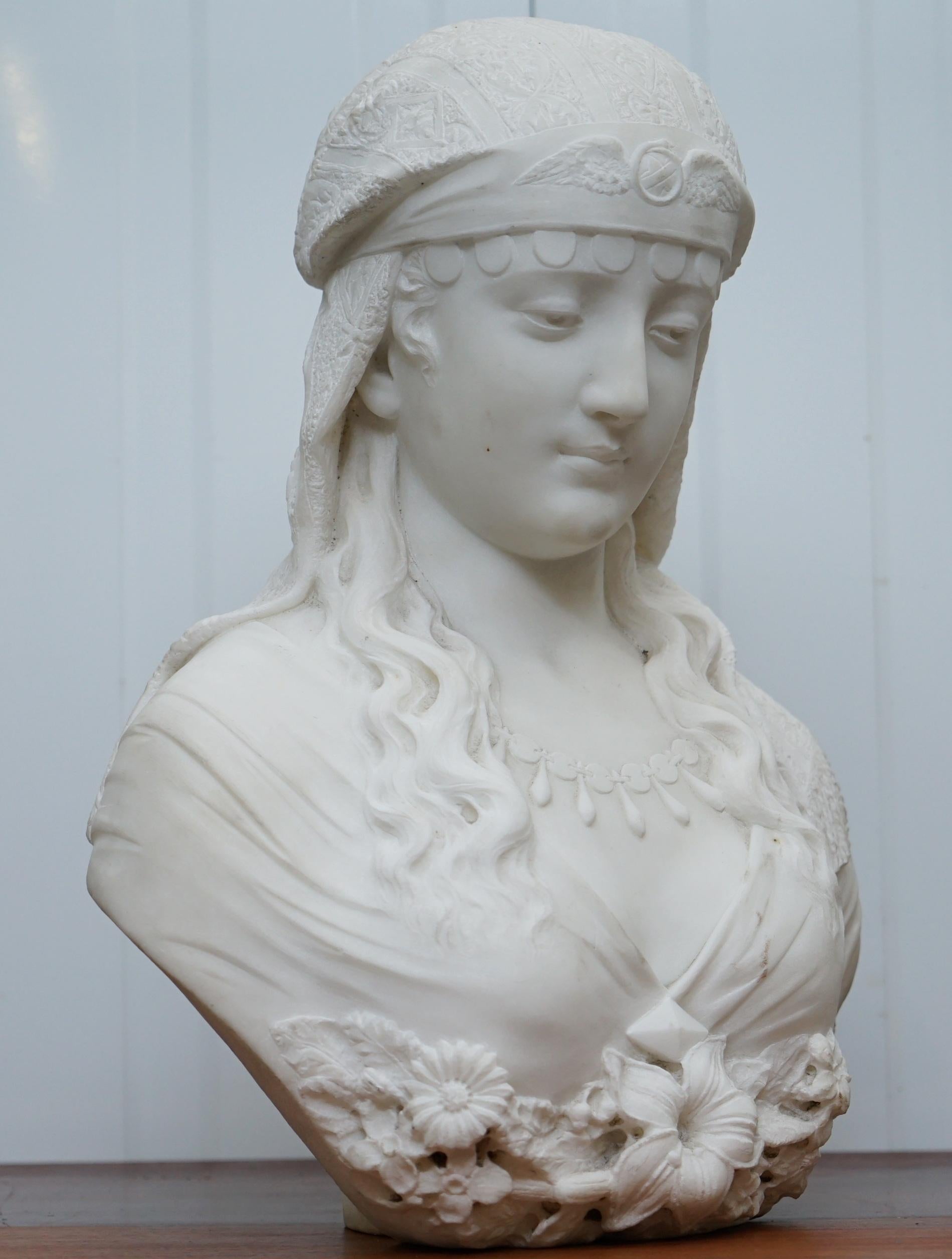 We are delighted to offer for sale this rare and quite exquisite 19th-century Italian white marble bust of a Maiden draped with flowers, a headscarf and necklace

A very romantic and idyllic looking piece, the expression on the good ladies face is