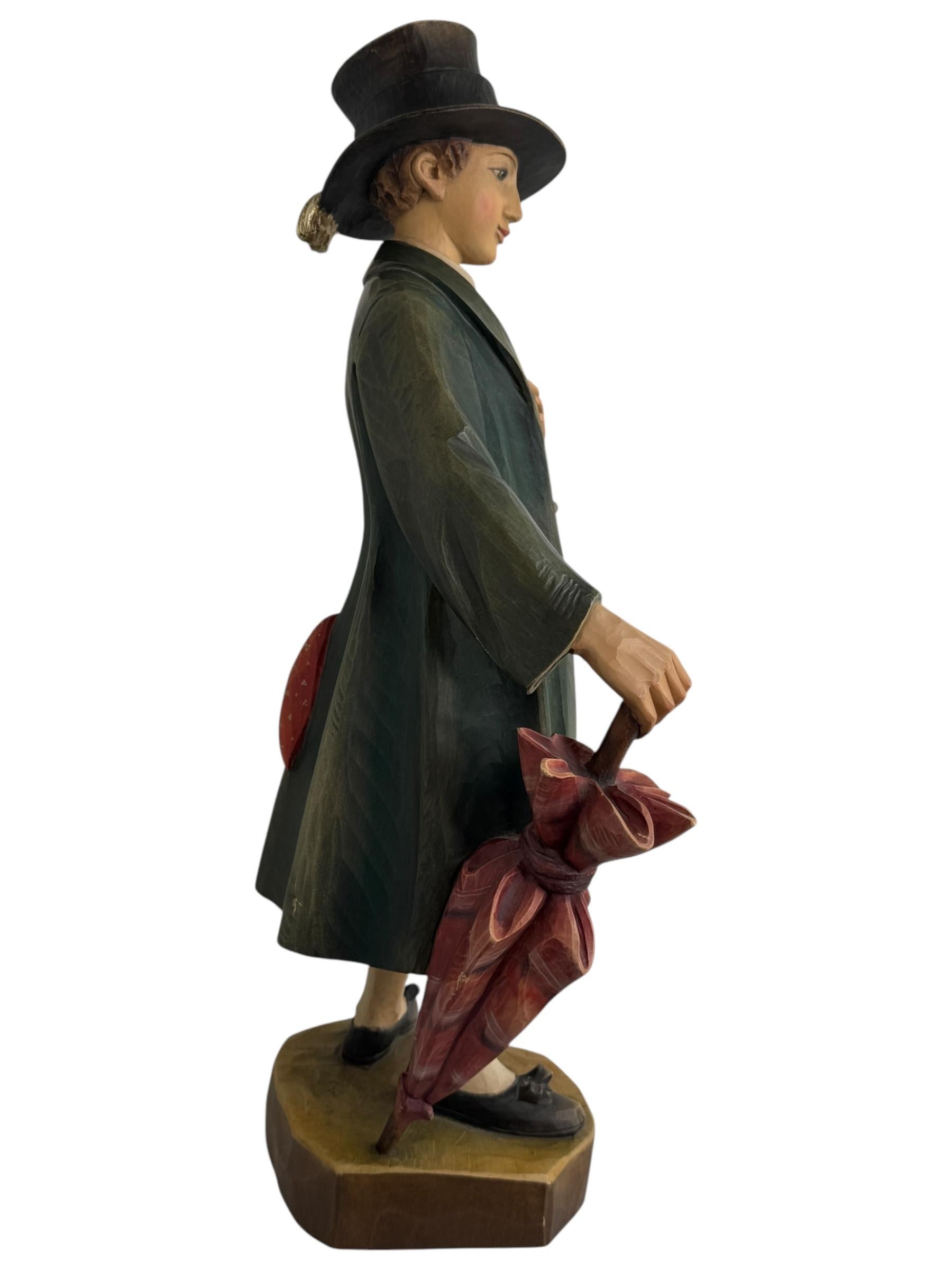 This vintage wood carving by Anri is a beautiful work of art depicting a man in traditional Groedner or Tyrolean costume. This wooden figure was made in the 1980s or older and is a large monumental piece. The intricate details of the wood carving