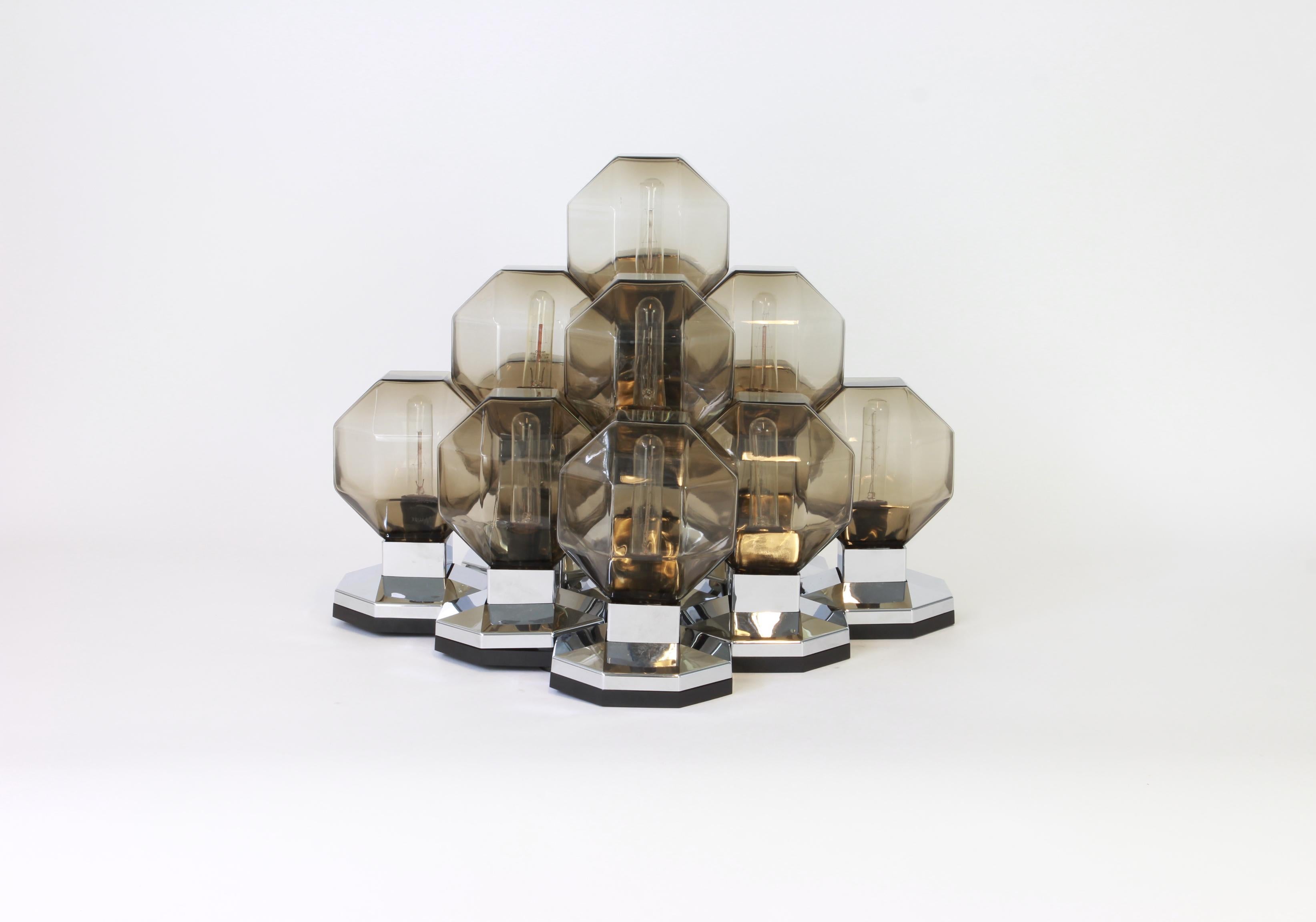 Stunning Space Age large modular flush mount by Designer: Motoko Ishii for staff, Germany, 1970s
Wonderful design with 13 smoked glasses on a chrome color frame.
This can be used as a ceiling , wall or Table lampe.

High quality and in very good