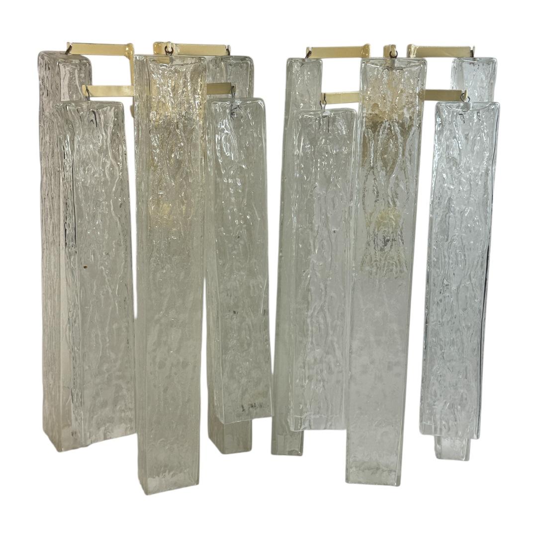 A stunning pair of Murano glass ice cube block wall sconces. Each consisting of a stylish design. A single white lacquered wall plate with two sockets on each plate and mount make for a beautiful wall light. Easy to mount and fantastic to look at.