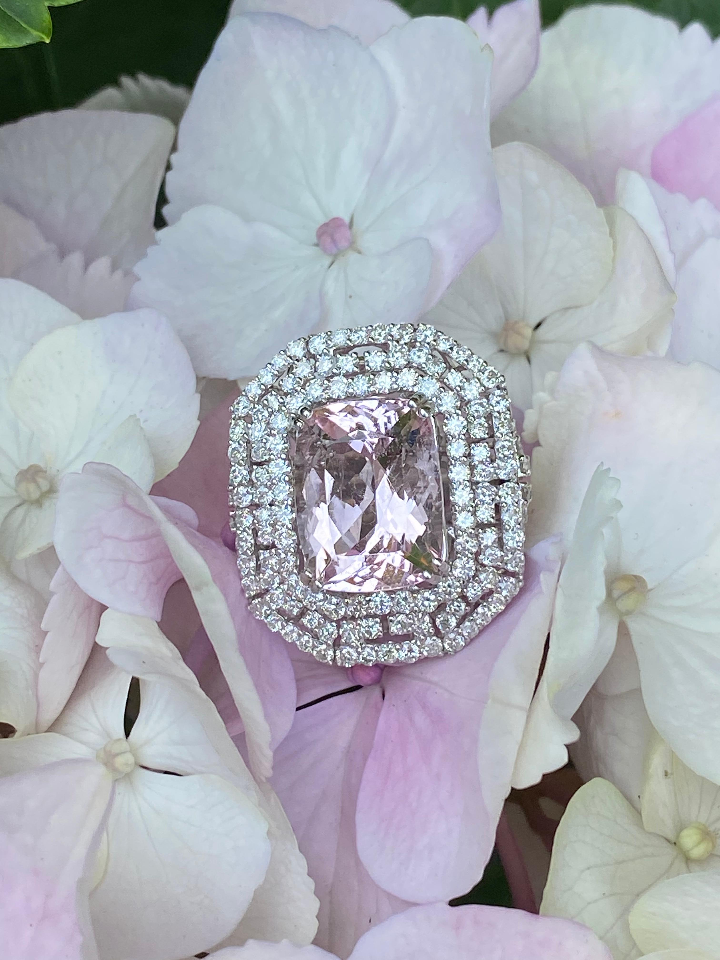 Magnificent 9.01 carat round cornered rectangular modified brilliant cut pink morganite and diamond ring is talon prong set above a mesmerizing three layer octagonal halo of round brilliant diamonds set in a repetitive pattern openwork design