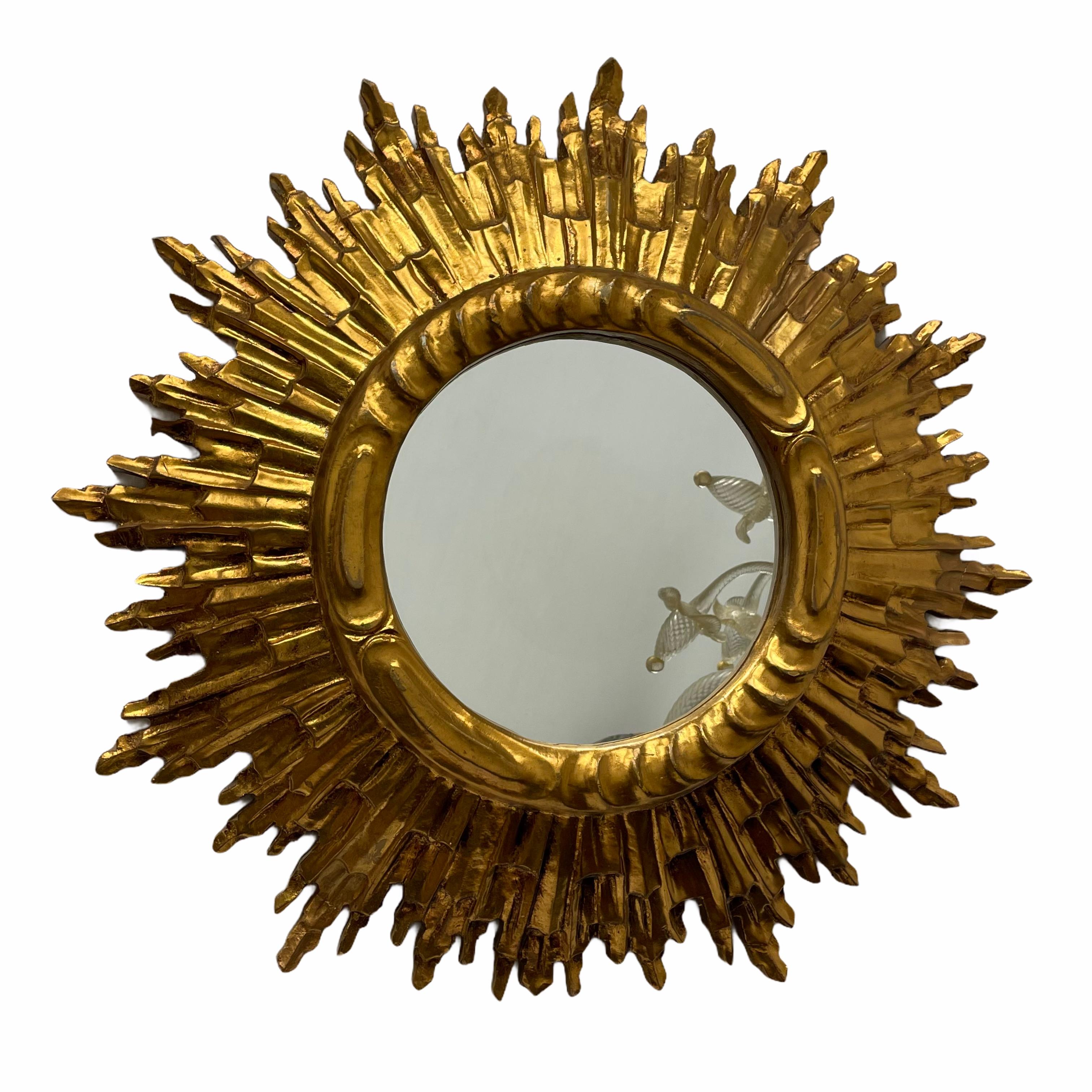 A gorgeous sunburst or starburst mirror. Made of gilded wood. It measures approximate: 23.63