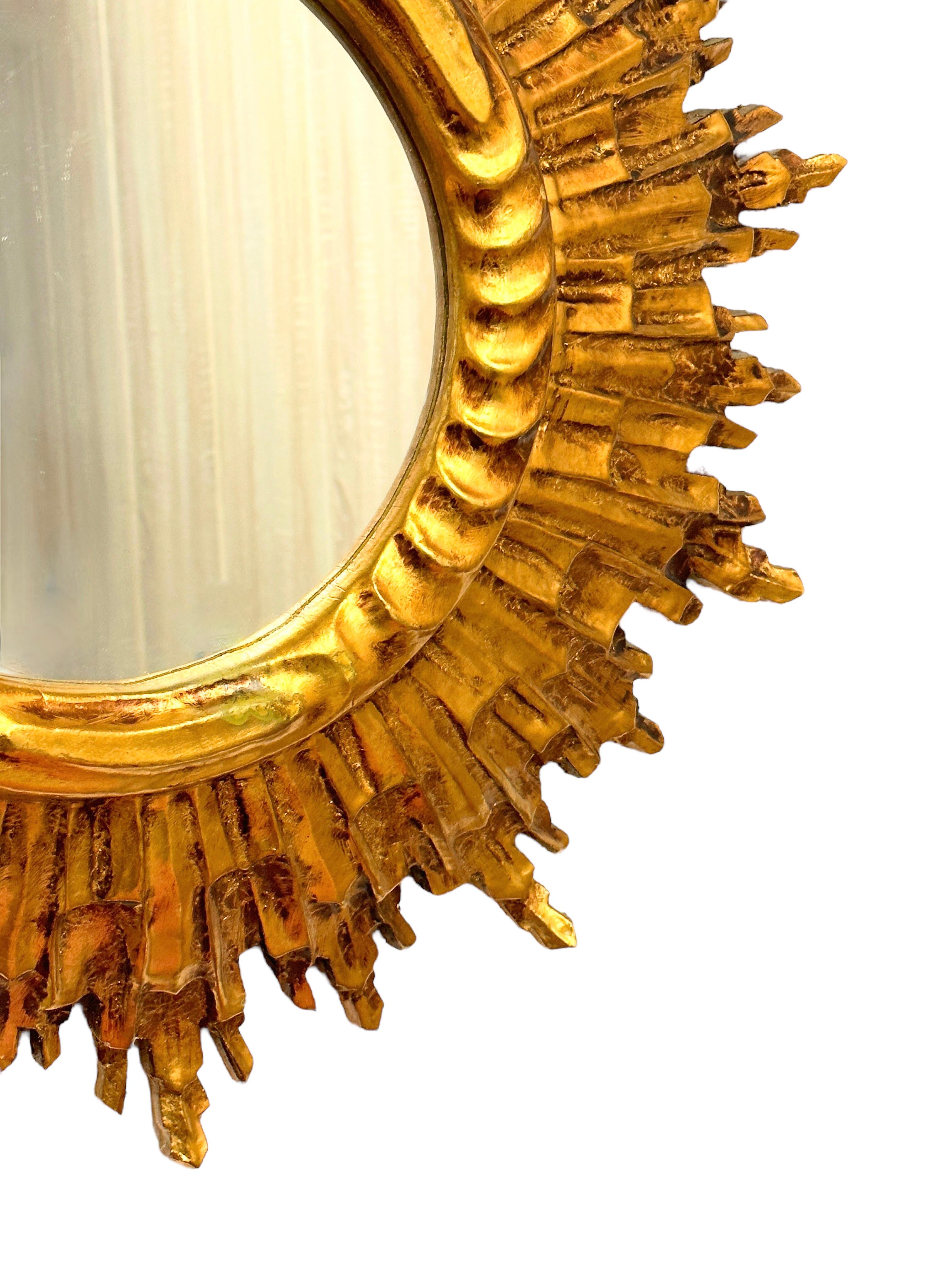 A gorgeous sunburst or starburst mirror. Made of gilded wood. It measures approximate: 24