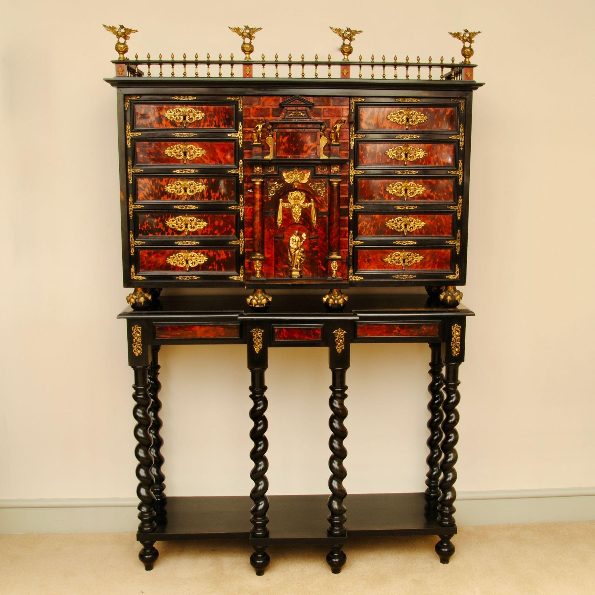 A superb late 17th century Spanish tortoiseshell and ormolu mounted cabinet on stand. The central architectural door opens to reveal a mirrored theatre. The stand a 19th century one made for this cabinet.