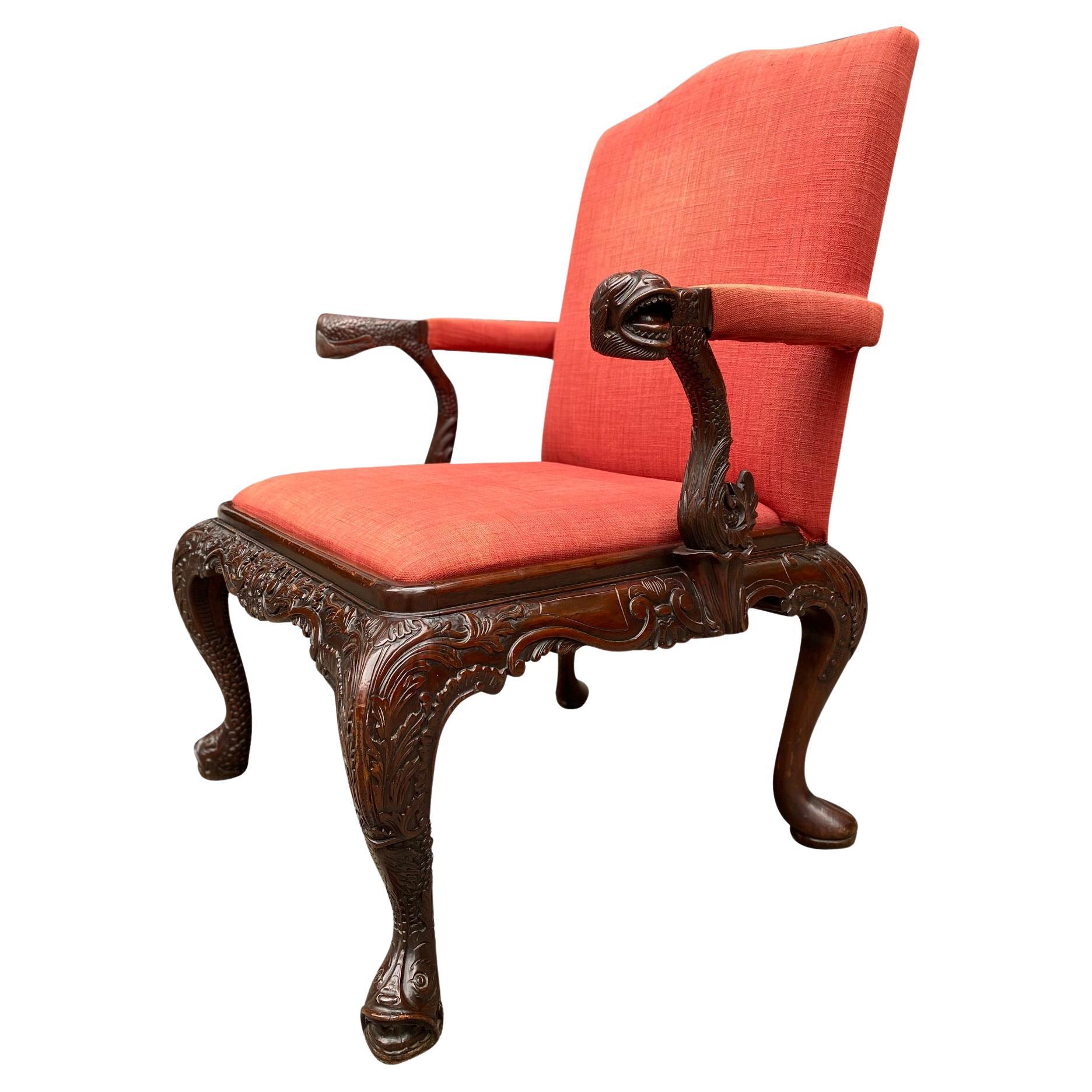 A superb quality late 19th century carved mahogany Gainsborough armchair, the camel high back flanked by arms with upholstered elbow pads and carved animal figures raised on carved scrolled uprights, the drop in seat above a wide foliate carved