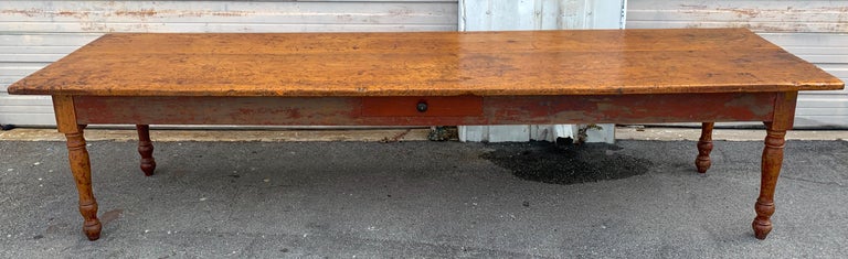 Stunning late 19th century southern red paint and chestnut farm table, of rectangular form the top constructed of two 138-inch x 31.5 inch and 23.5 inch wide beautifully patinated boards. The lower case with some red paint remaining Fitted with one