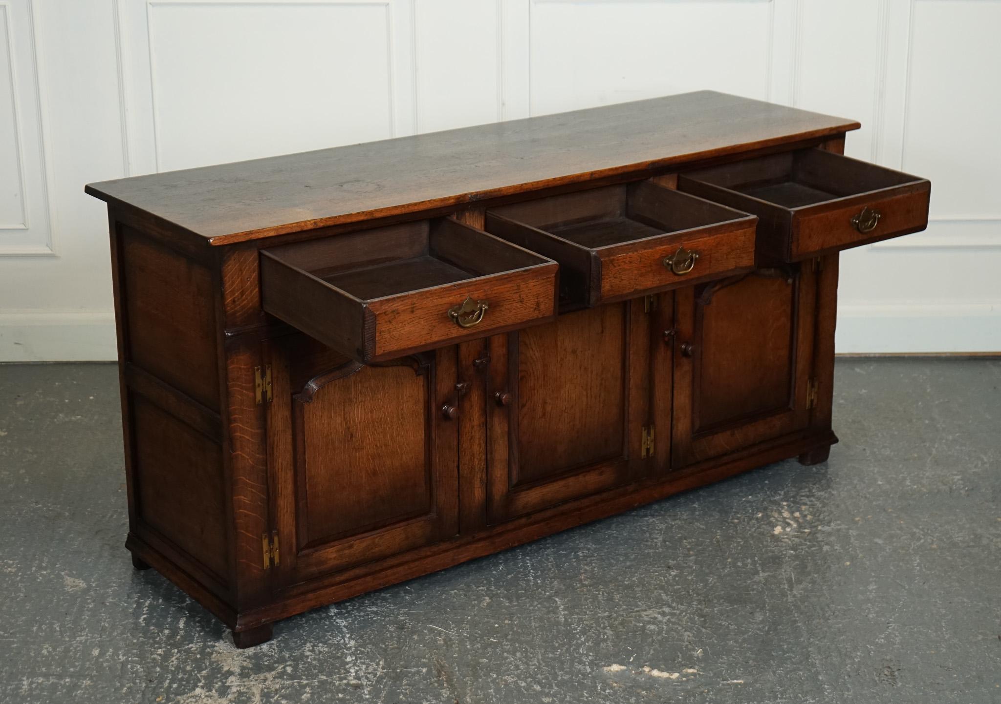 
We are delighted to offer for sale this Lovely Titchmarsh & Goodwin Solid Oak Sideboard.

The stunning late 20th-century Titchmarsh & Goodwin solid oak dresser sideboard is a showstopper of a piece that commands attention with its exceptional