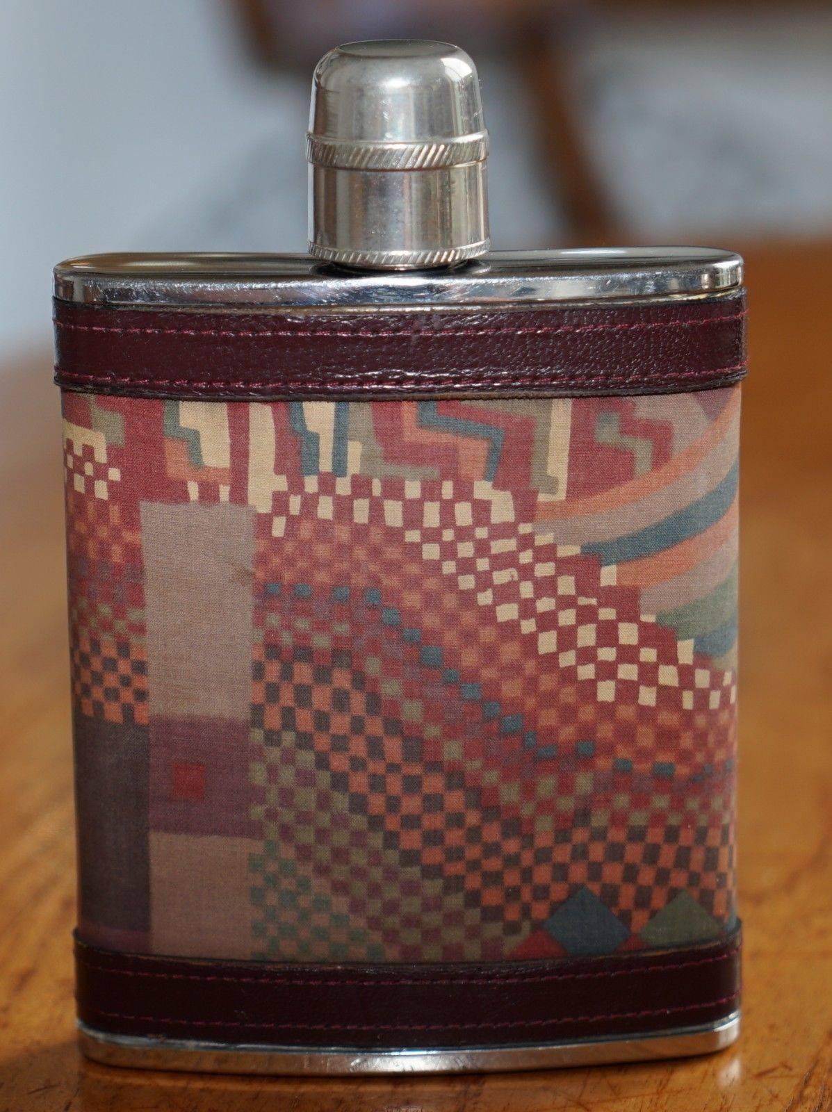 We are delighted to offer for sale this absolutely stunning handmade in England Liberty London hip flask

Full stamped to the base stainless steel 6oz, the cover is aged brown saddle leather and kilim, the leather is gold leaf embossed
