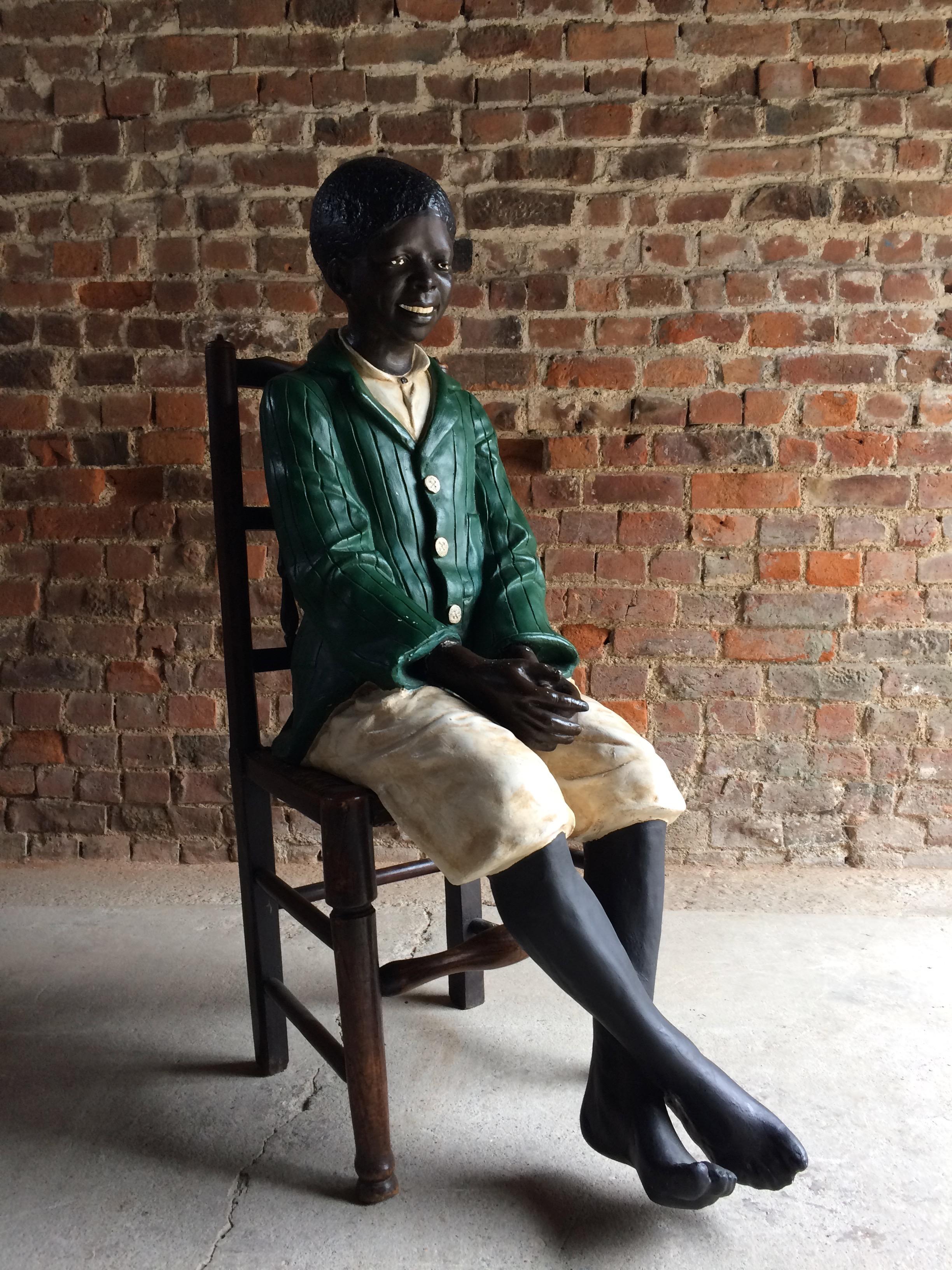 Stunning Friedrich Goldscheider style life size plaster figure of a seated smiling African American boy on a wooden chair.

Dimensions:


Height 48
