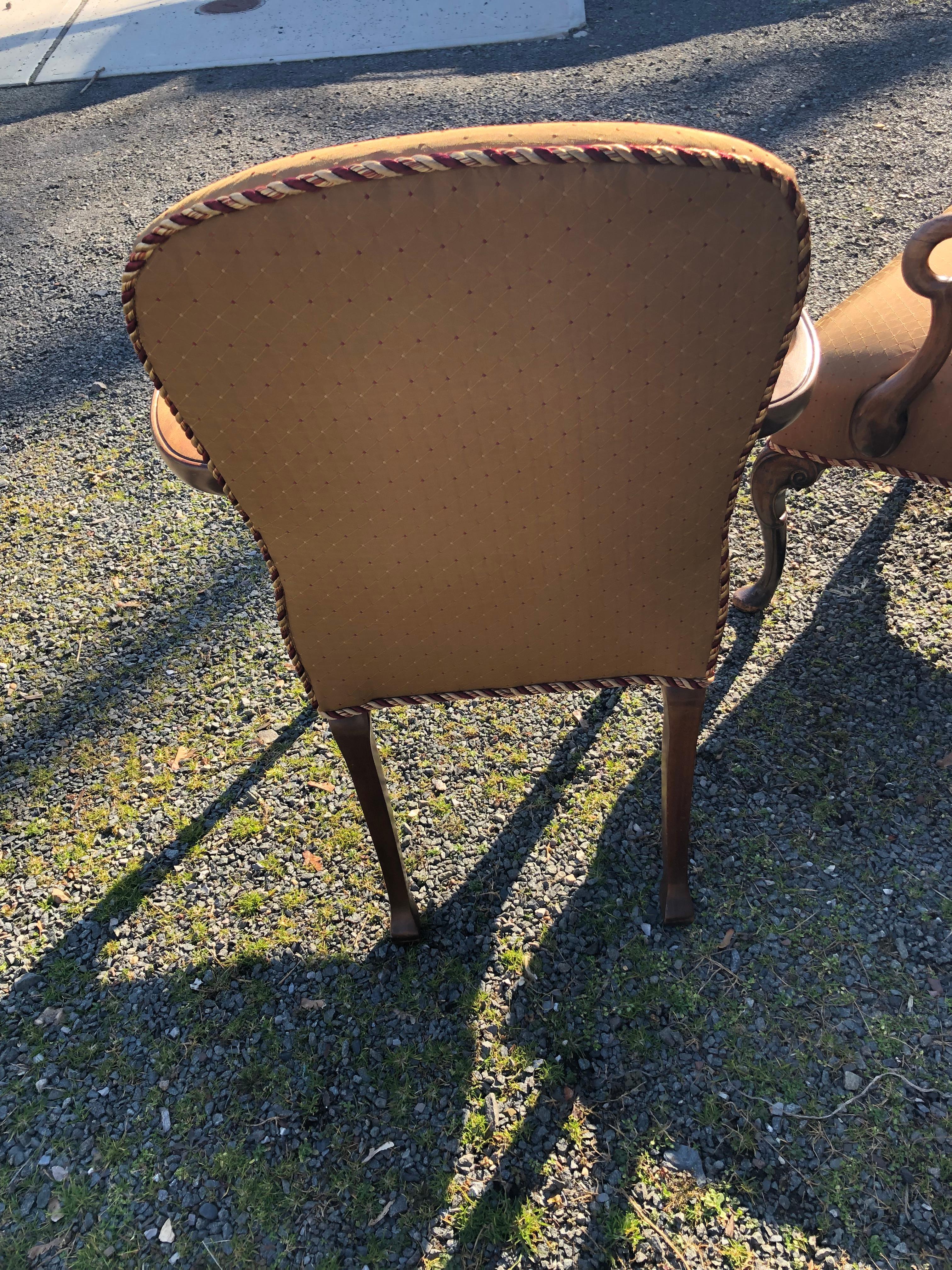 Great looking versatile armchair having light colored brown wood curvy arms and pretty legs with carvings on top.  The top is rounded.  Newly upholstered in a handsome taupey fabric.
Note:  A square back armchair in matching fabric goes well matched
