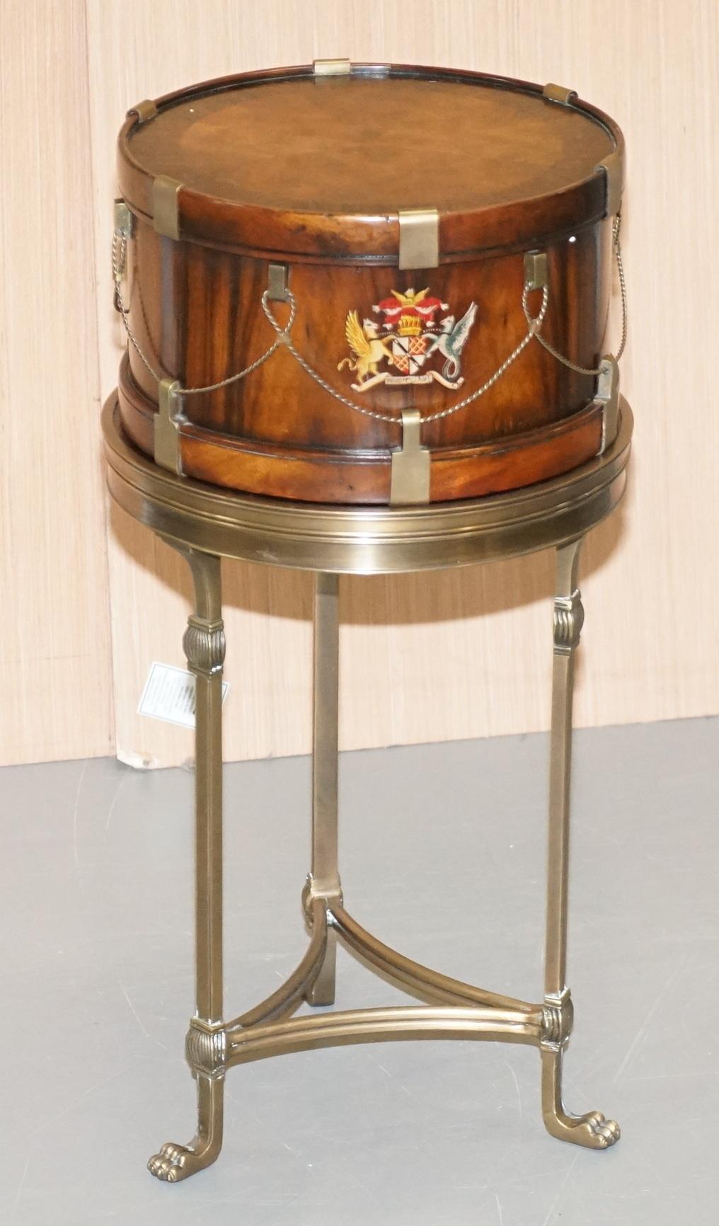 We are delighted to offer for sale this lovely walnut timber framed with bronzed stand drum table with internal storage and armorial crest in the form of an actual drum

This is a very good looking and decorative side table, it looks like a