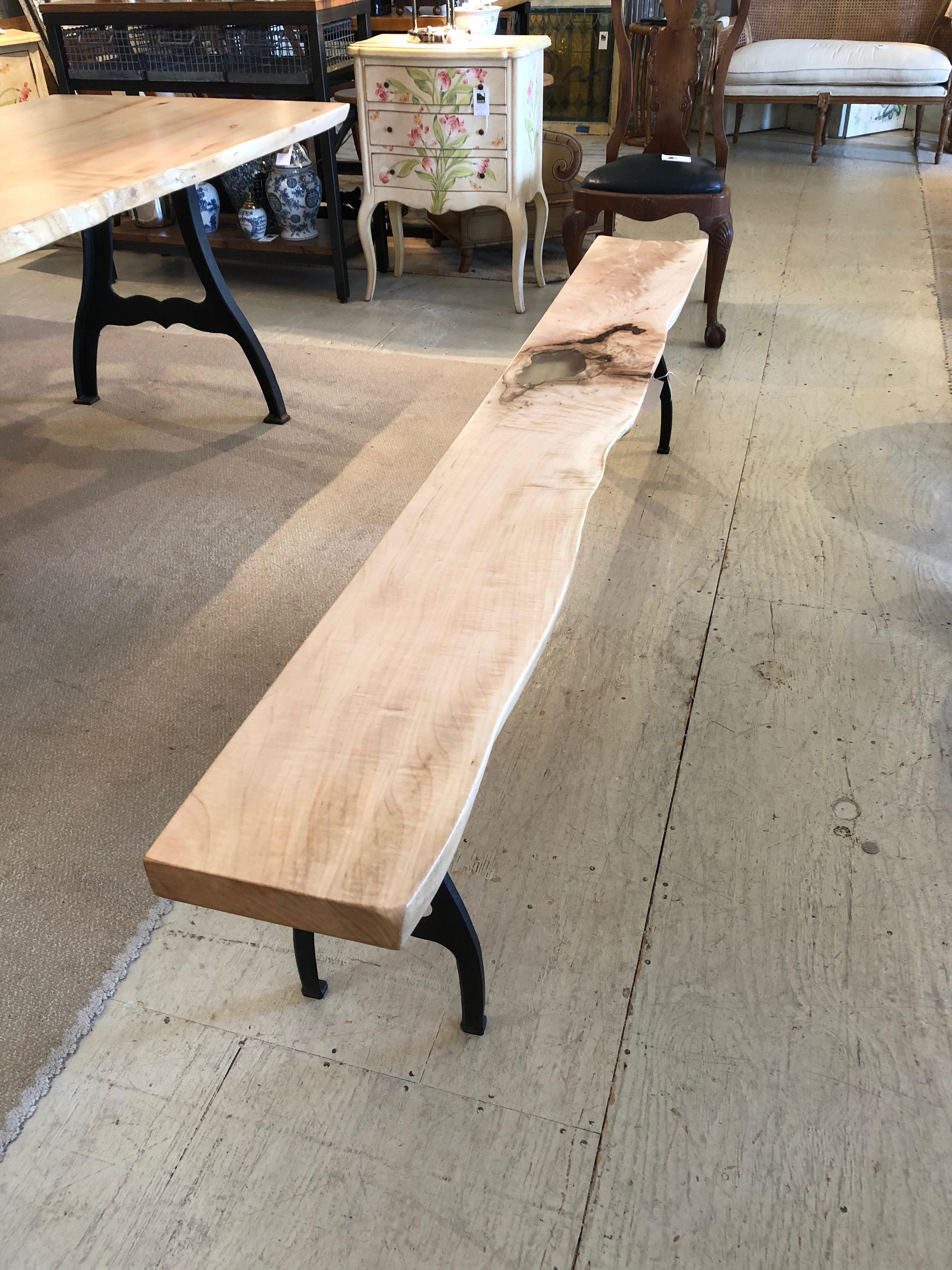 Gorgeously crafted long bench in a lovely light shade of solid maple having live edges, filled in one area with clear resin, and paired with iron industrial legs.

Note: Matching 7 ft dining table offered. Price upon request.