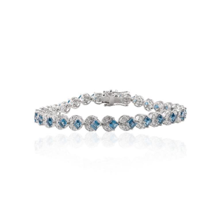 Beautifully handcrafted London Blue Topaz and Diamond Tennis Bracelet, designed with love, including handpicked luxury gemstones for each designer piece. Grab the spotlight with this exquisitely crafted piece. Inlaid with natural blue topaz